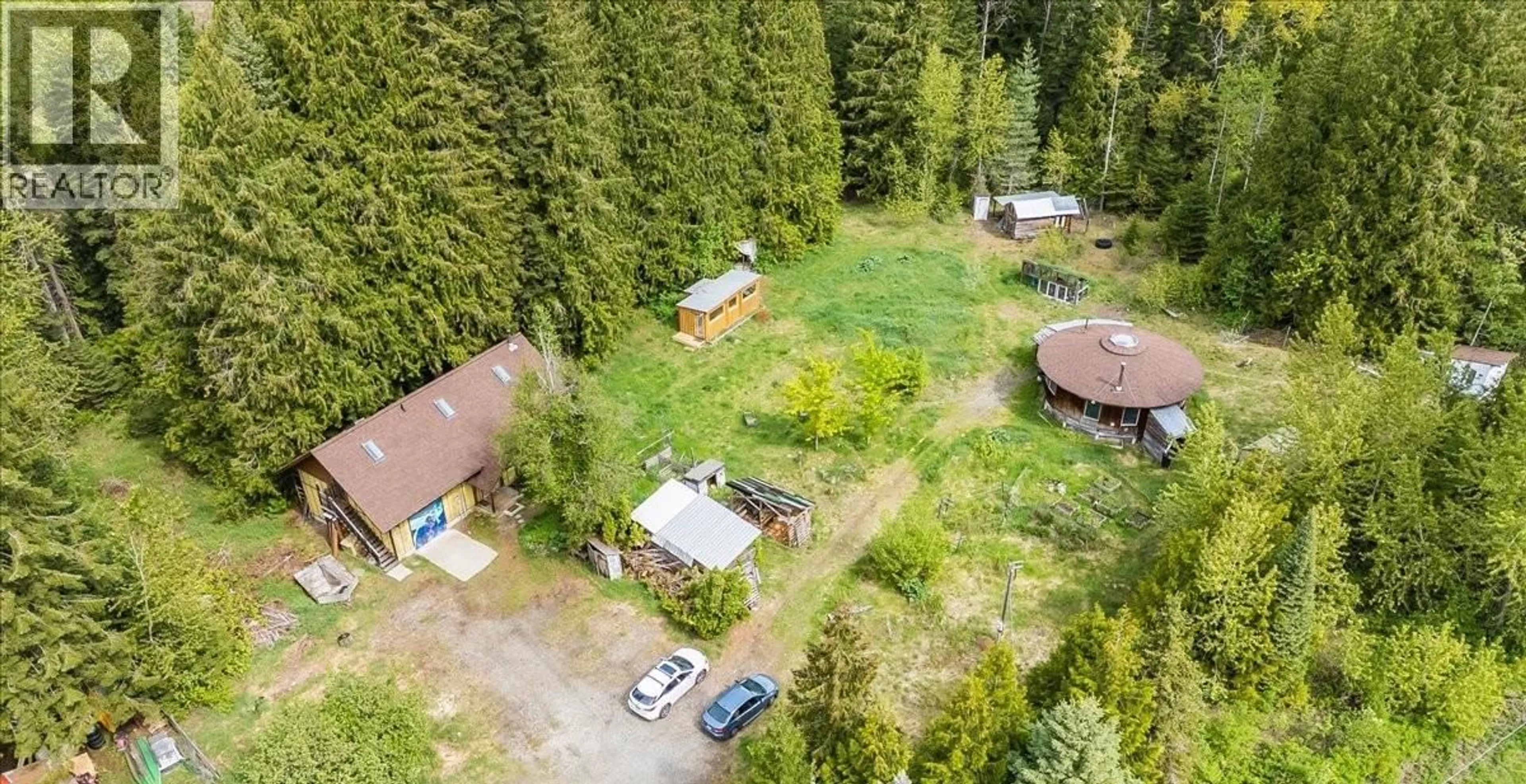 A pic from outside/outdoor area/front of a property/back of a property/a pic from drone, forest/trees view for 216 PORCUPINE CREEK ROAD, Ymir British Columbia V0G2K0