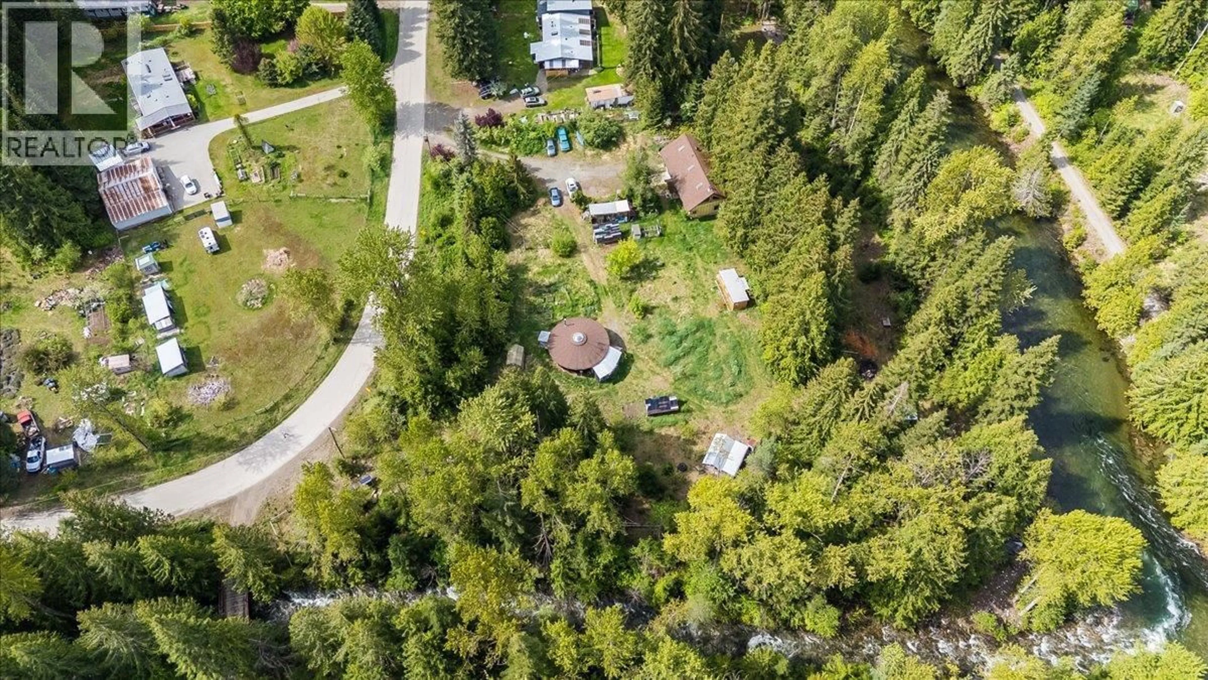 A pic from outside/outdoor area/front of a property/back of a property/a pic from drone, forest/trees view for 216 PORCUPINE CREEK ROAD, Ymir British Columbia V0G2K0