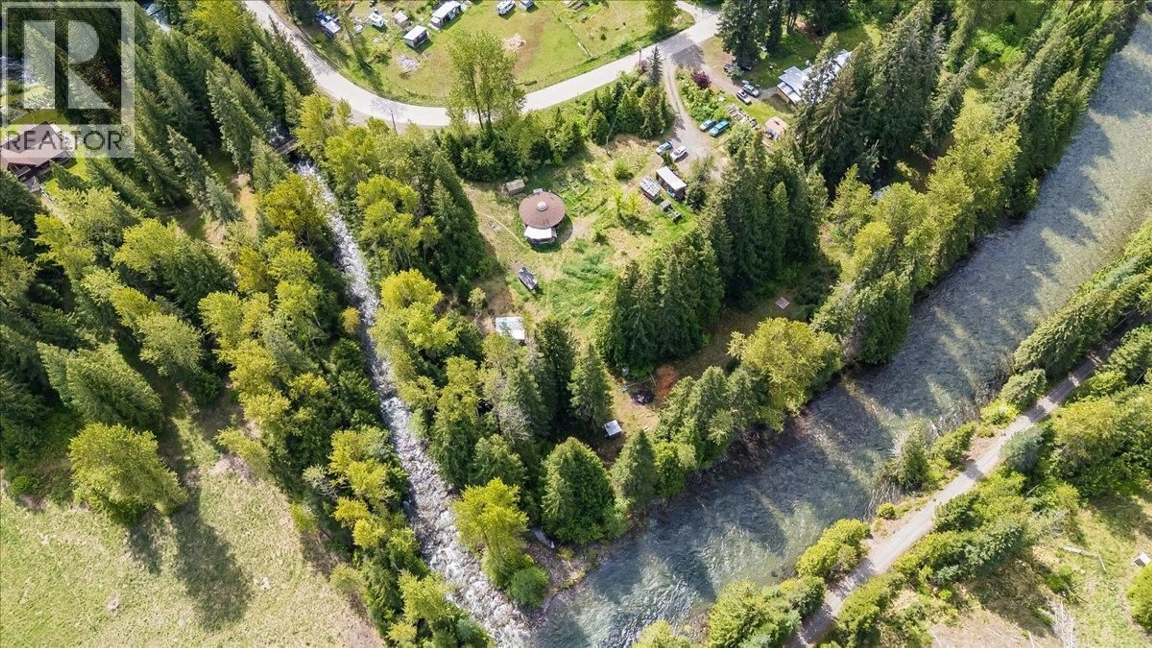 A pic from outside/outdoor area/front of a property/back of a property/a pic from drone, forest/trees view for 216 PORCUPINE CREEK ROAD, Ymir British Columbia V0G2K0