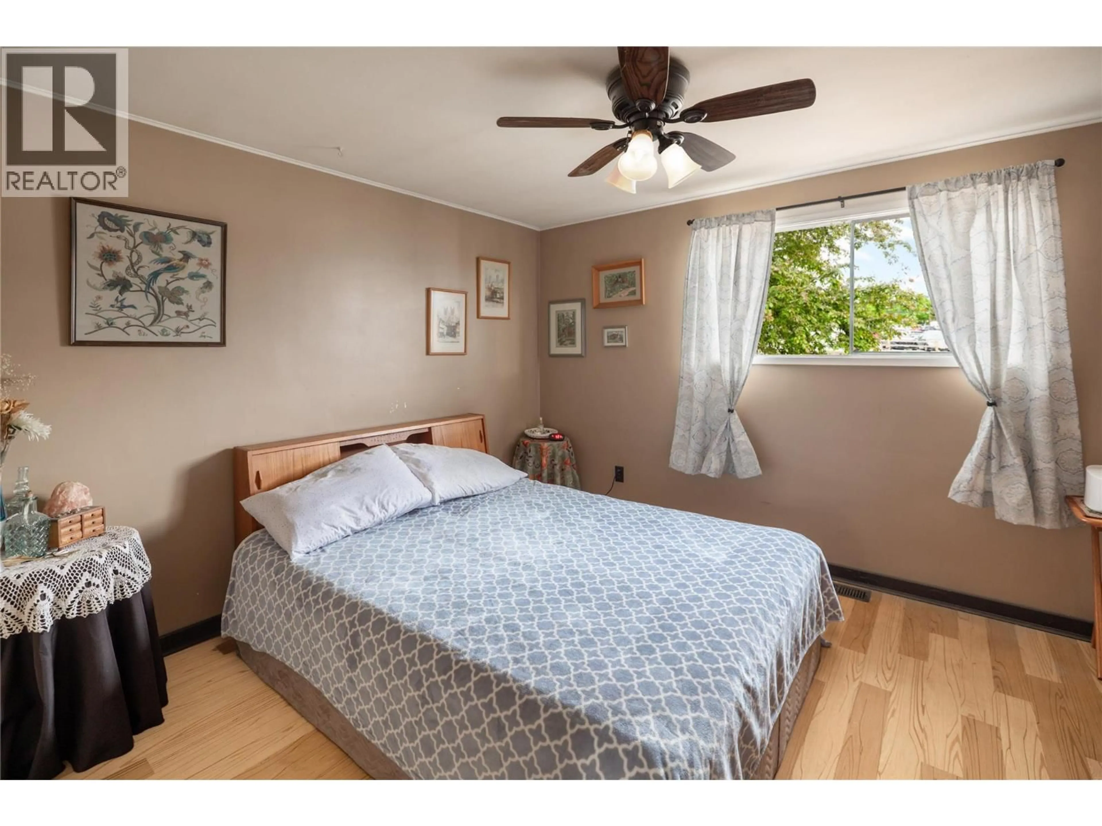 Bedroom with bed, wood/laminate floor for 2150 BURNETT STREET, Kelowna British Columbia V1Y2T6