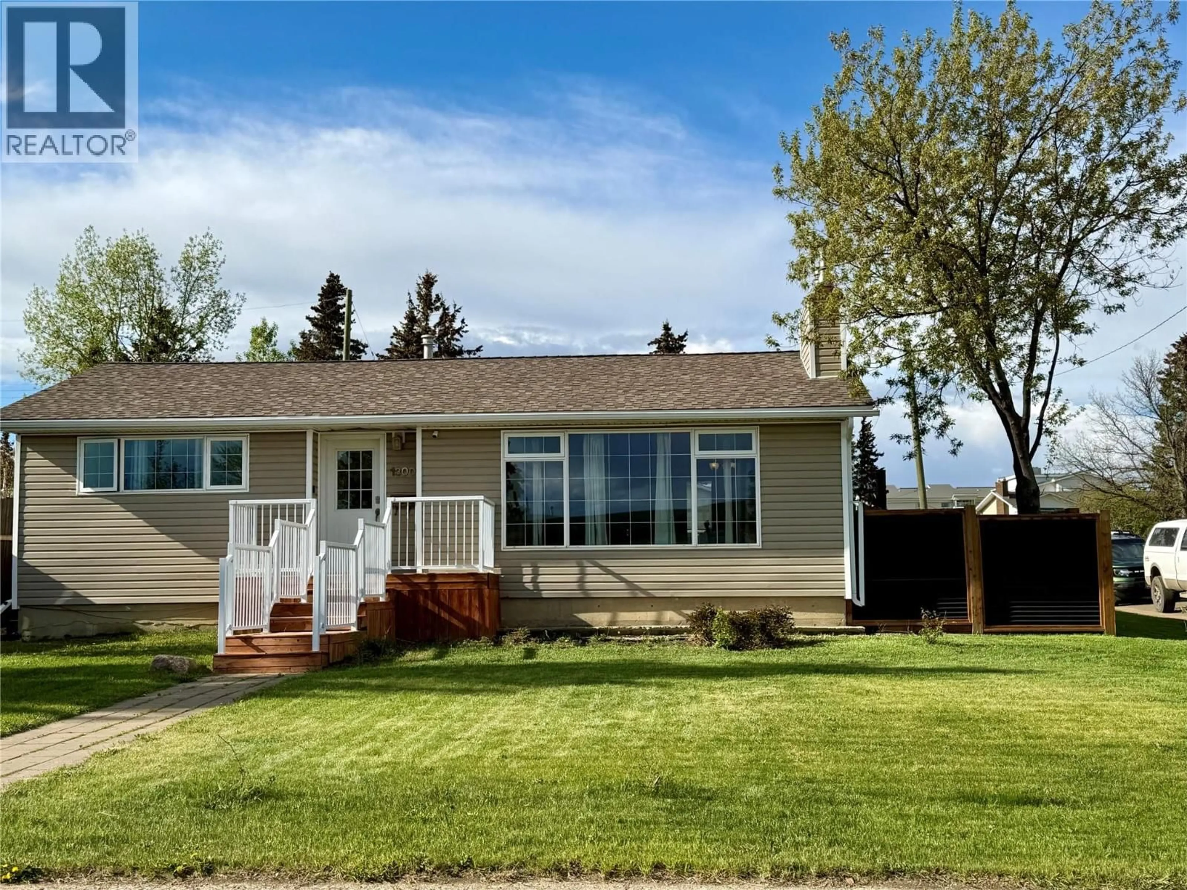 Home with vinyl exterior material, street for 1300 93 AVENUE, Dawson Creek British Columbia V1G1E4