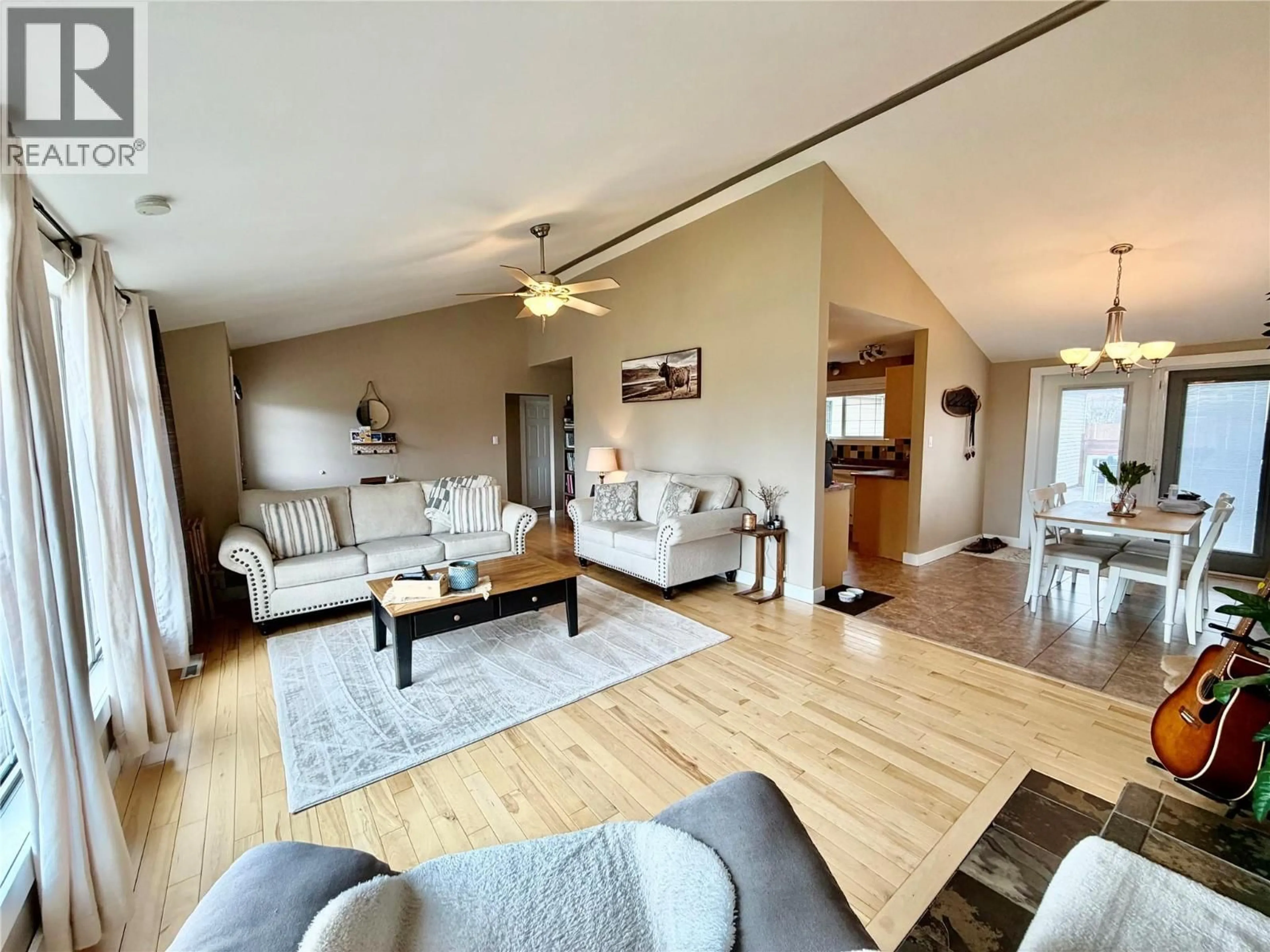 Living room with furniture, wood/laminate floor for 1300 93 AVENUE, Dawson Creek British Columbia V1G1E4