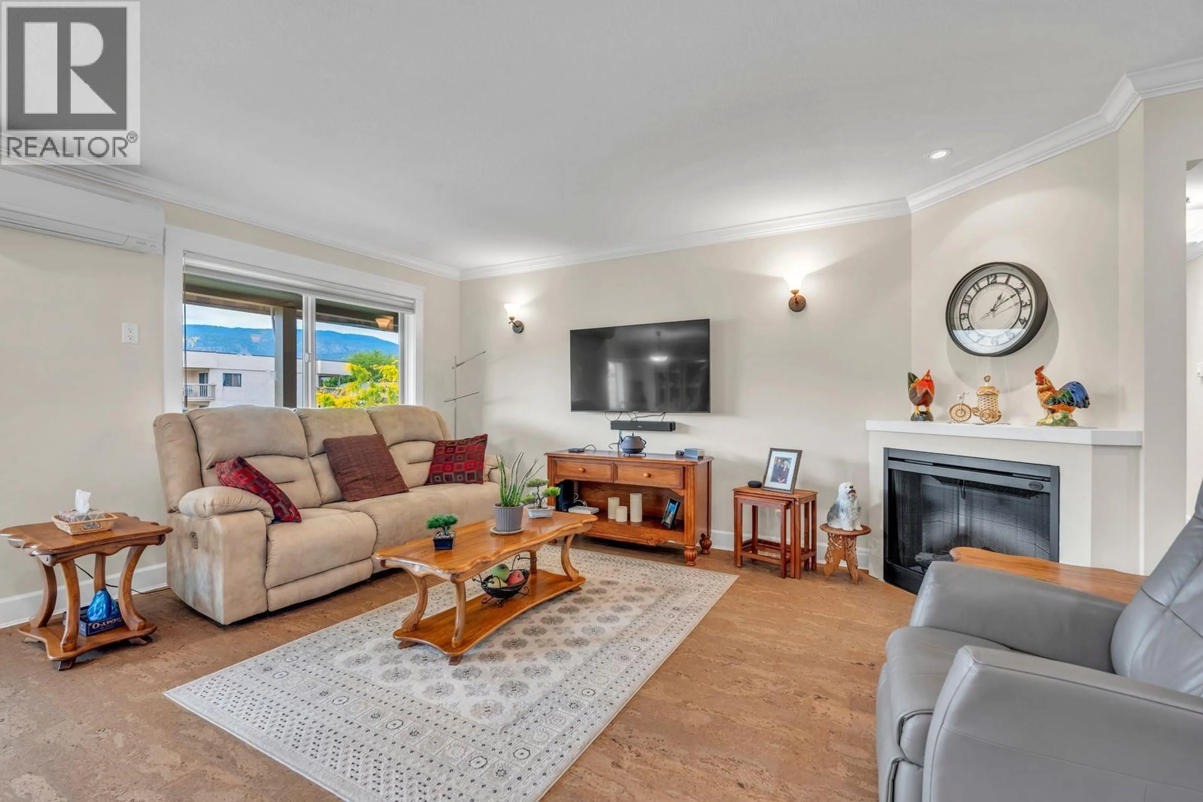 Living room with furniture, wood/laminate floor for 201 - 1830 ATKINSON STREET, Penticton British Columbia V2A7M6