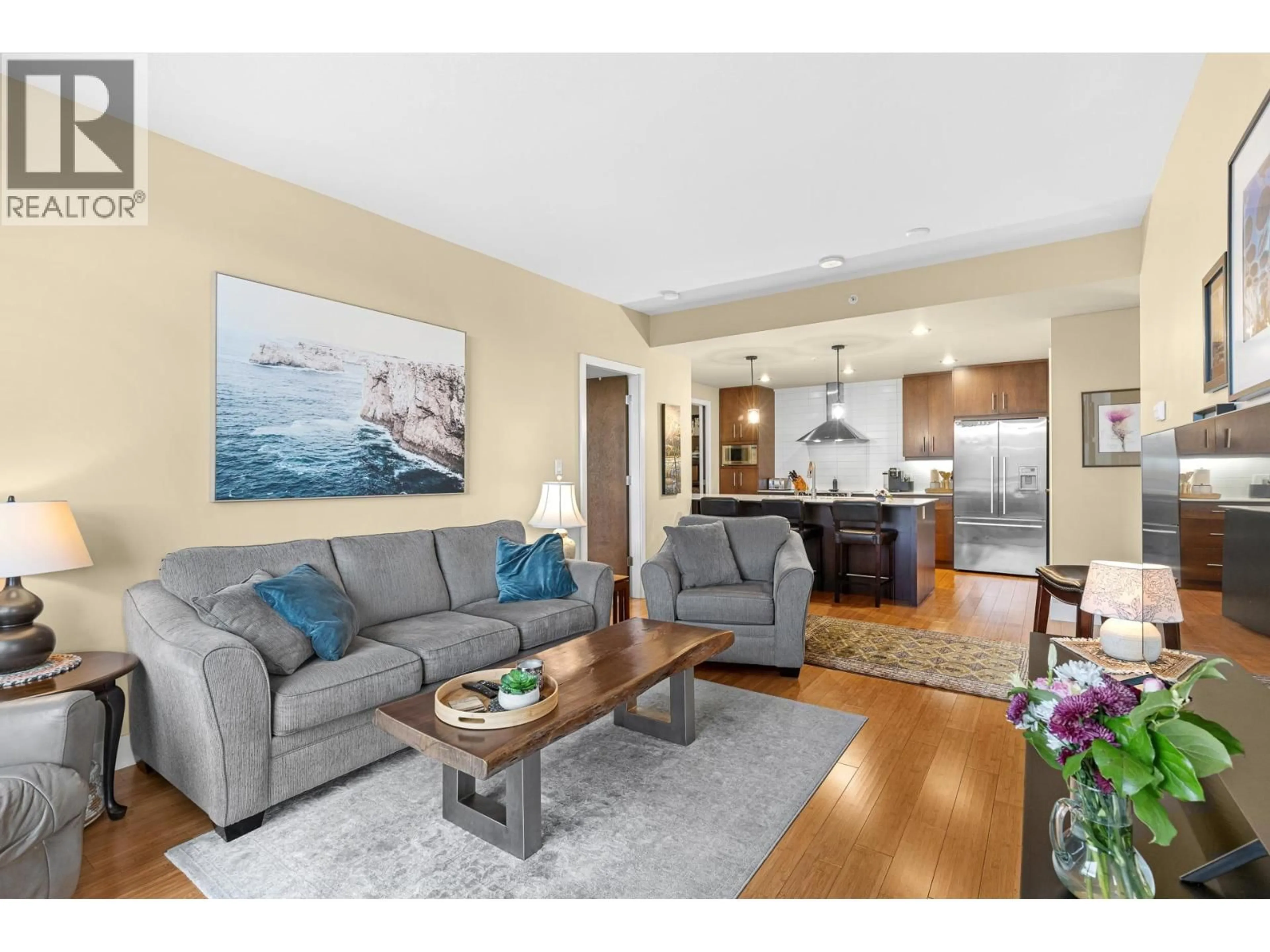 Living room with furniture, wood/laminate floor for 1008 - 2040 SPRINGFIELD ROAD, Kelowna British Columbia V1Y9N7
