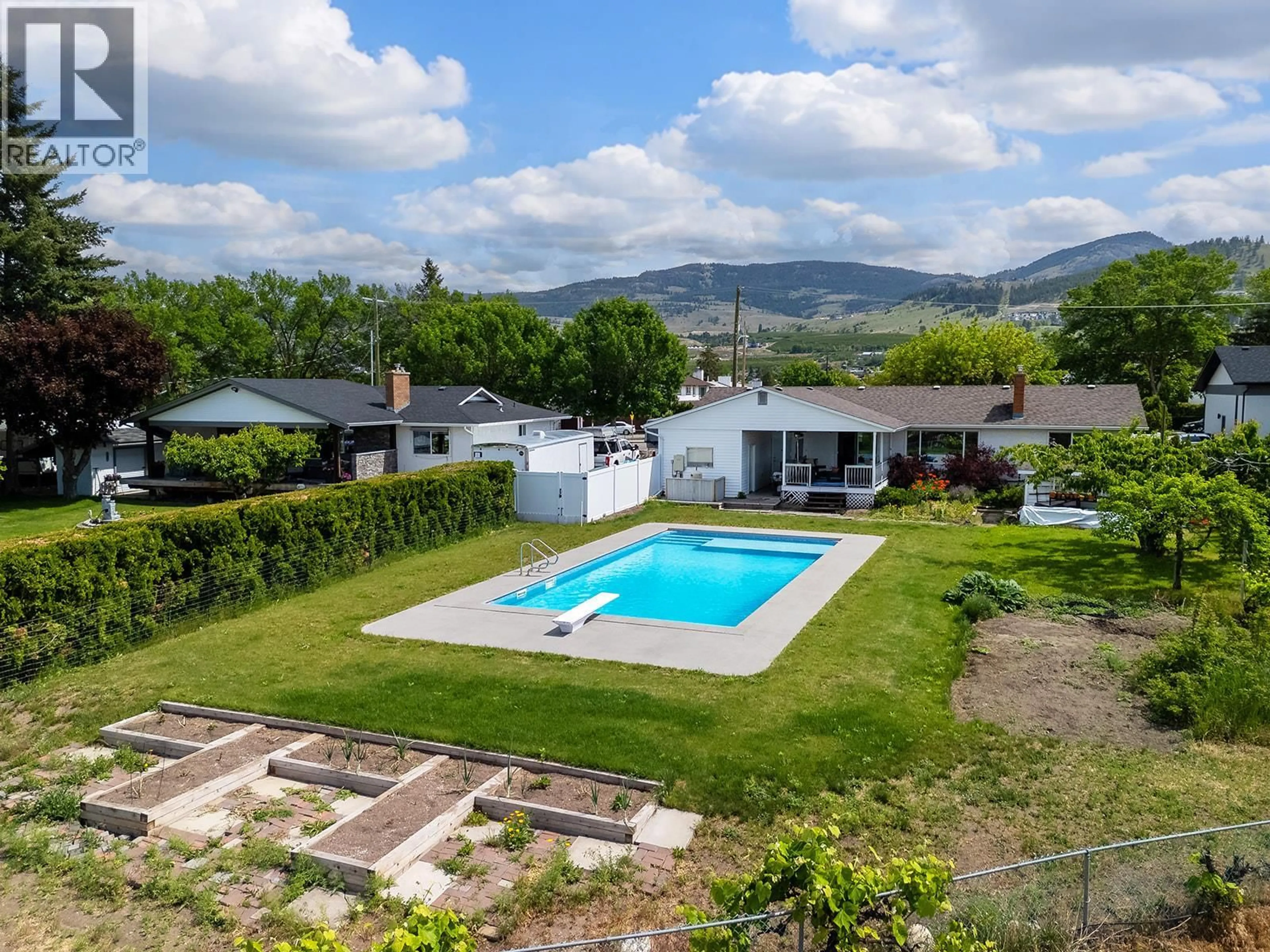 A pic from outside/outdoor area/front of a property/back of a property/a pic from drone, mountain view for 650 DOUGALL ROAD SOUTH, Kelowna British Columbia V1X3J8