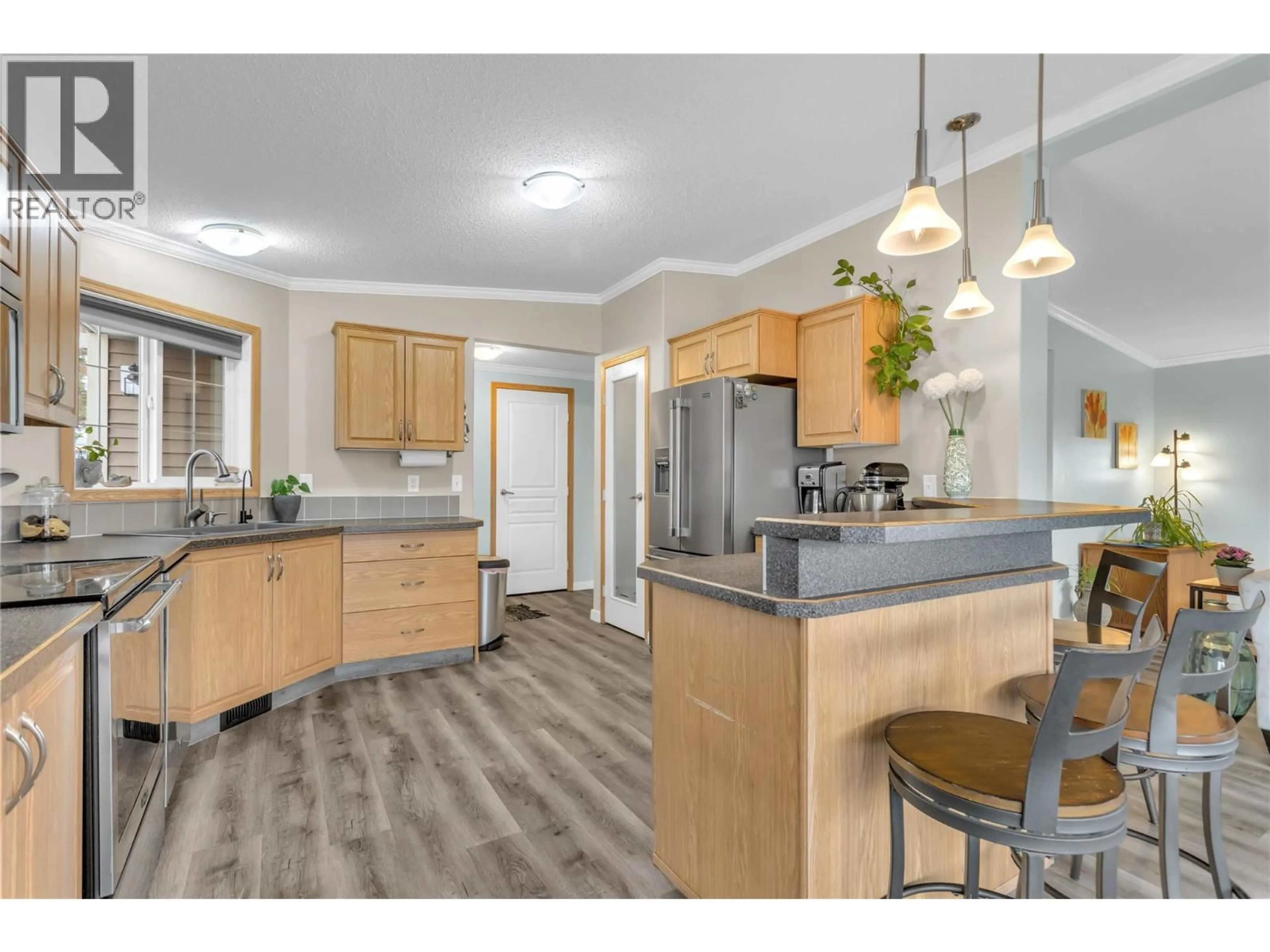 Open concept kitchen, wood/laminate floor for 151 - 9020 JIM BAILEY ROAD, Kelowna British Columbia V4V1E5