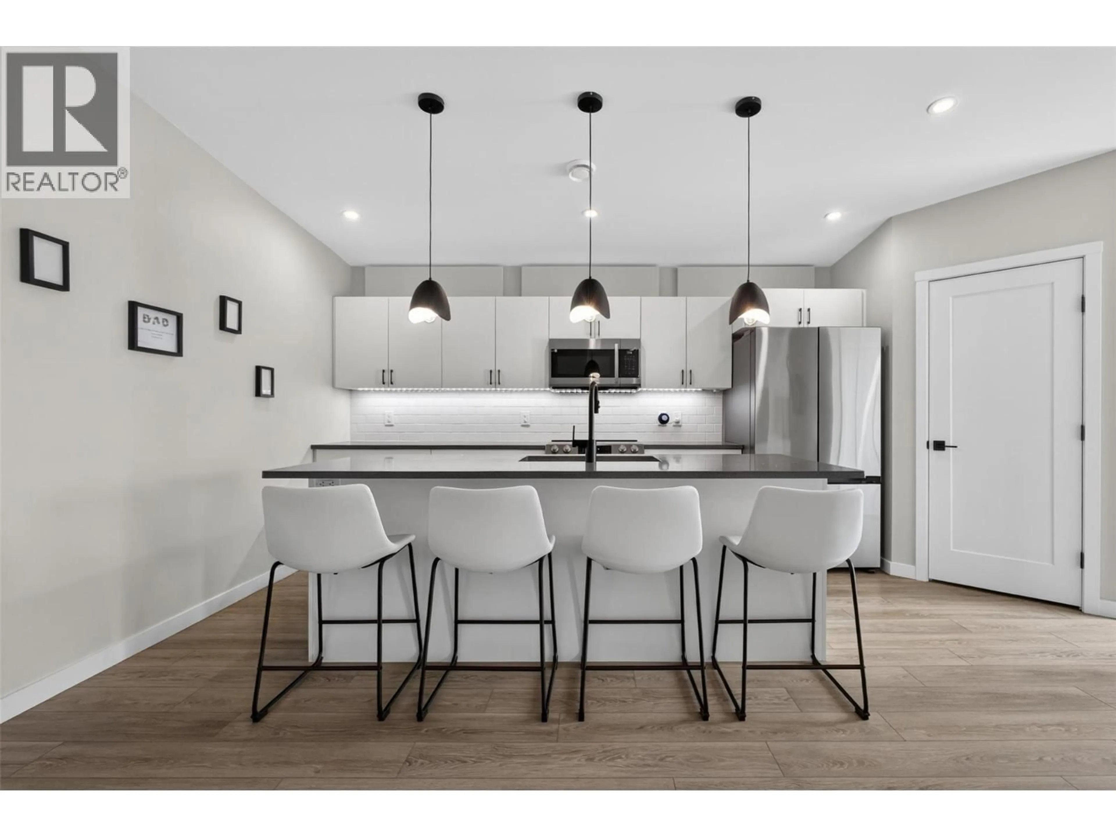 Open concept kitchen, wood/laminate floor for 13 - 8900 JIM BAILEY ROAD, Kelowna British Columbia V4V0B5