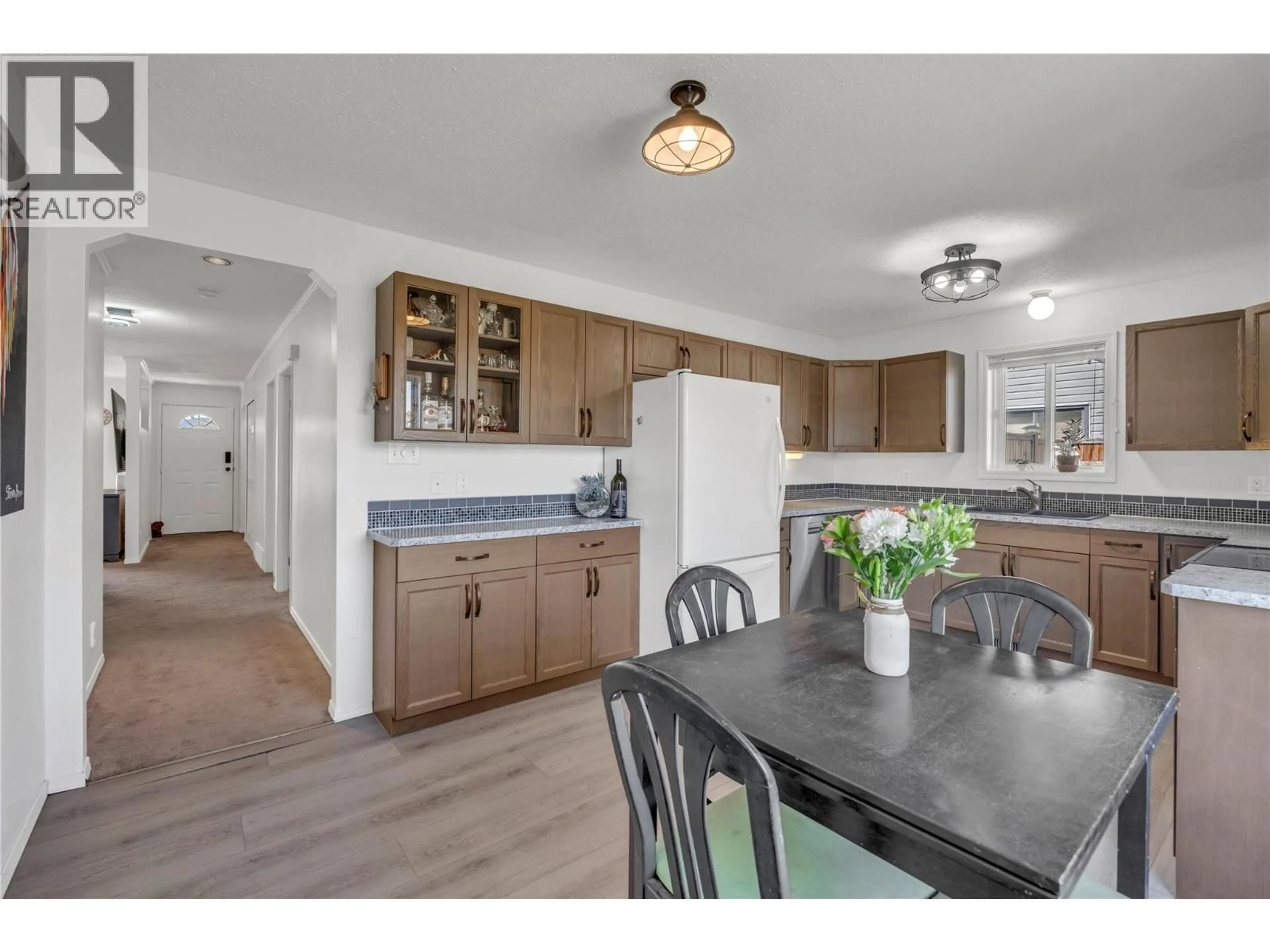Open concept kitchen, wood/laminate floor for 9714 SARGEANT STREET, Summerland British Columbia V0H1Z3