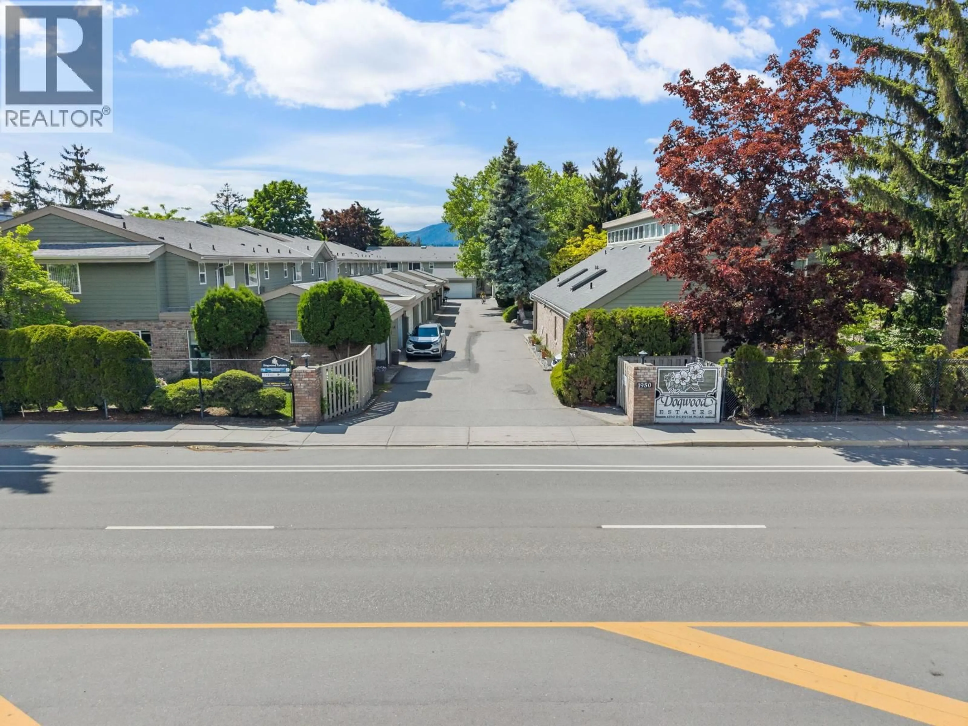A pic from outside/outdoor area/front of a property/back of a property/a pic from drone, street for 13 - 1950 BURTCH ROAD, Kelowna British Columbia V1Y4B2