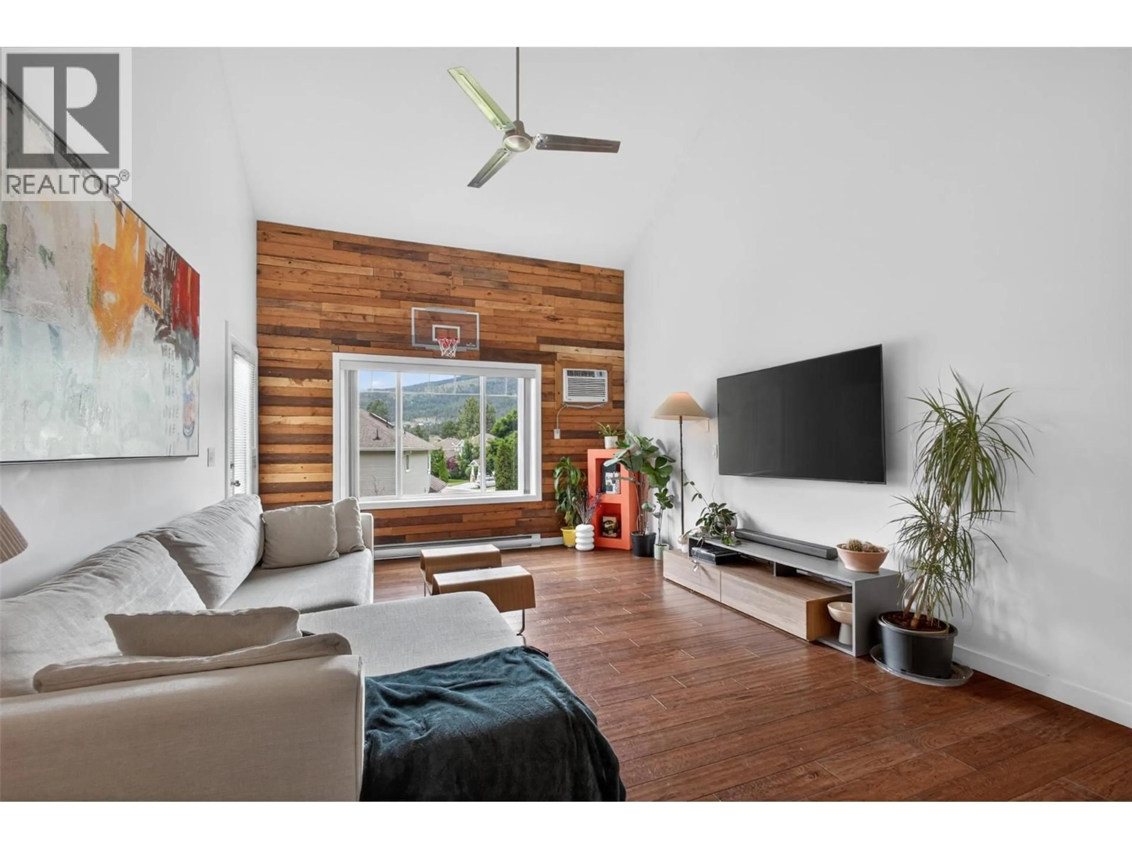 Living room with furniture, wood/laminate floor for 303 - 2120 SHANNON RIDGE DRIVE, West Kelowna British Columbia V4T2Z3