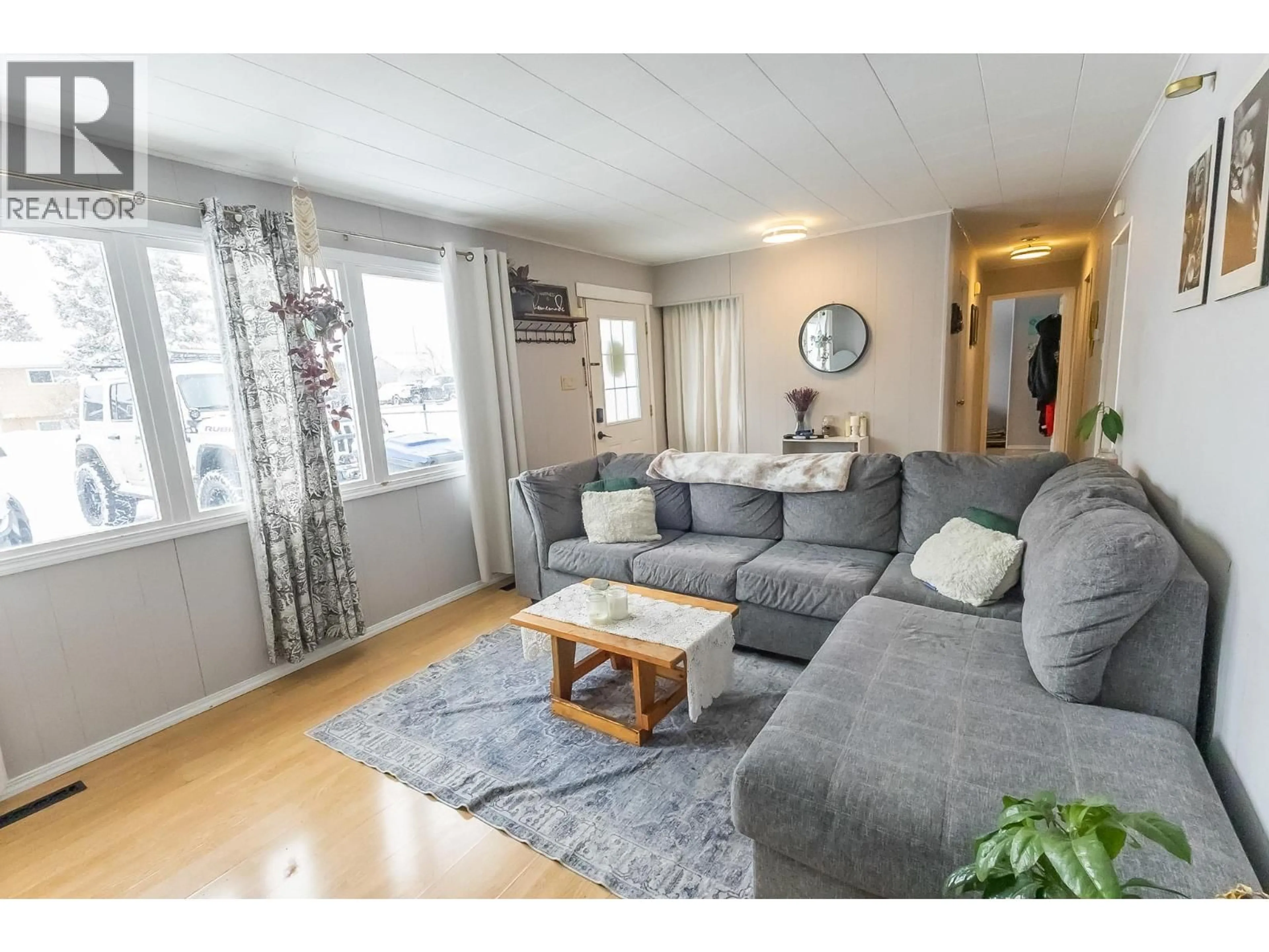 Living room with furniture, wood/laminate floor for 1016 120 AVENUE, Dawson Creek British Columbia V1G3J7