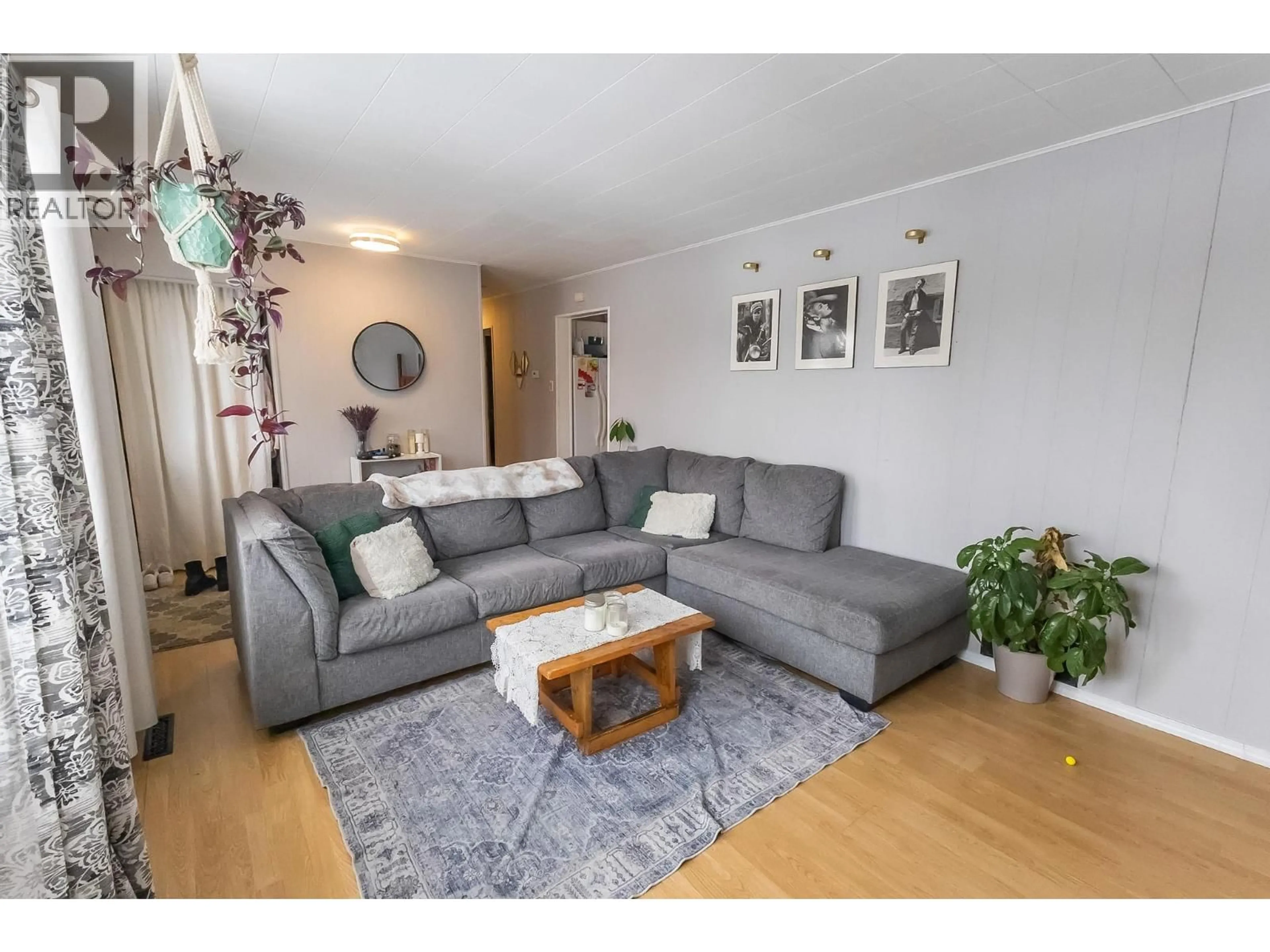 Living room with furniture, wood/laminate floor for 1016 120 AVENUE, Dawson Creek British Columbia V1G3J7
