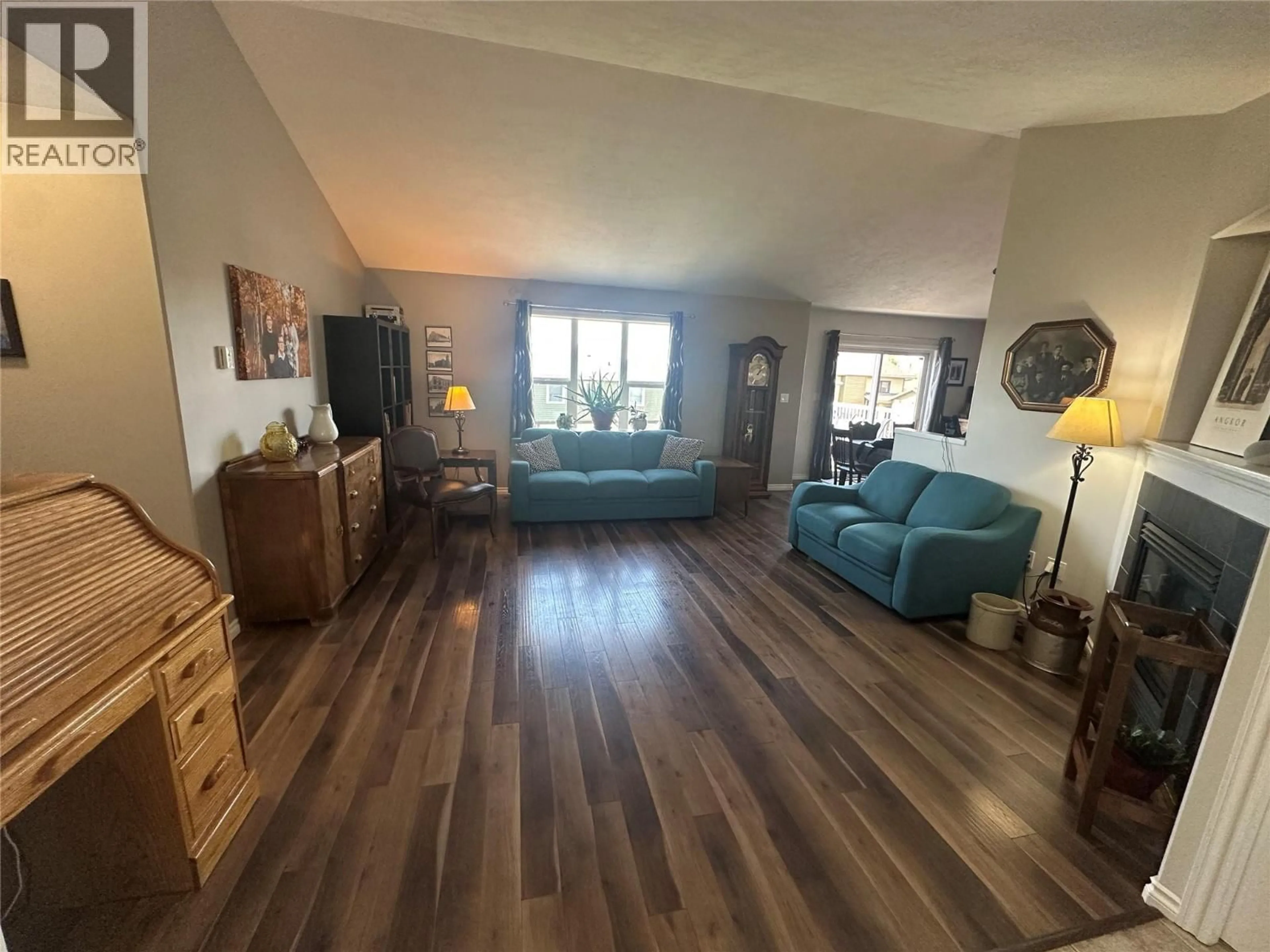 Living room with furniture, wood/laminate floor for 8713 19A STREET, Dawson Creek British Columbia V1G0A7