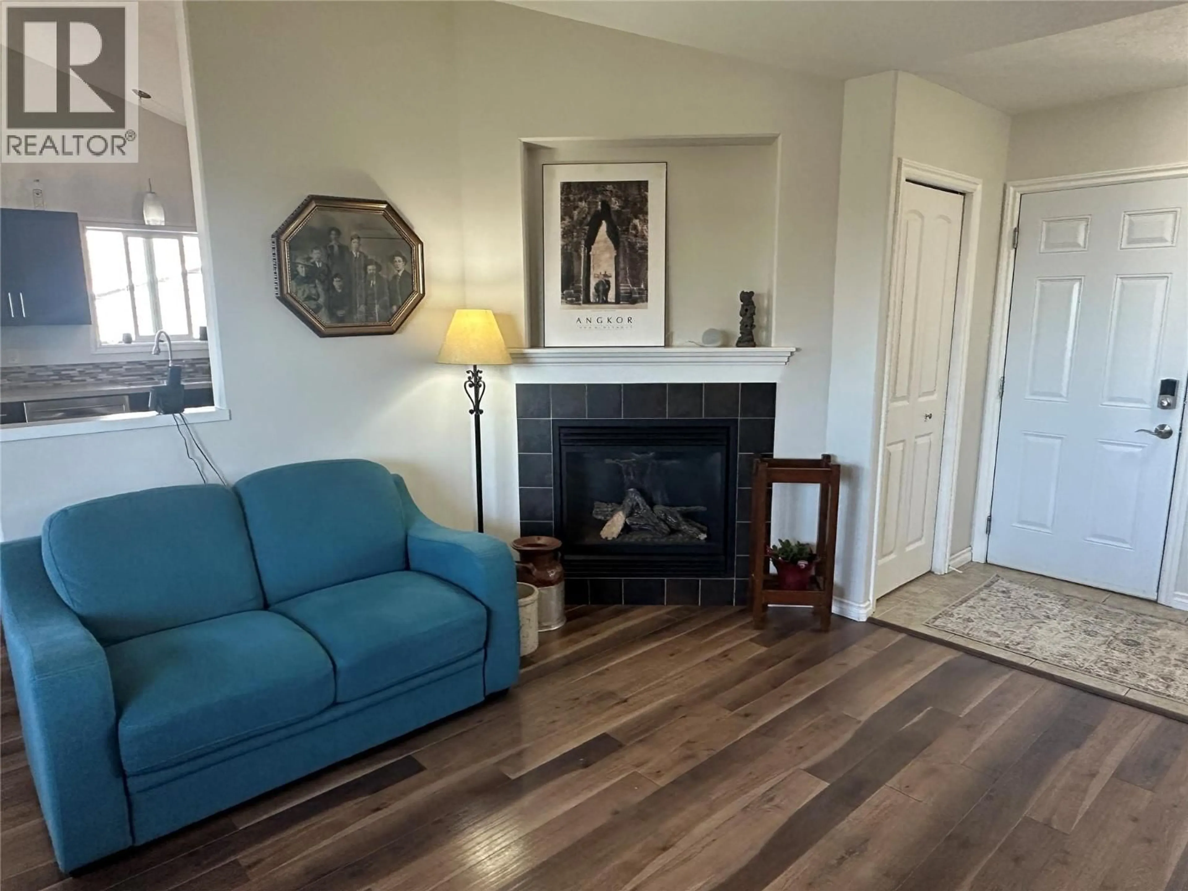 Living room with furniture, wood/laminate floor for 8713 19A STREET, Dawson Creek British Columbia V1G0A7