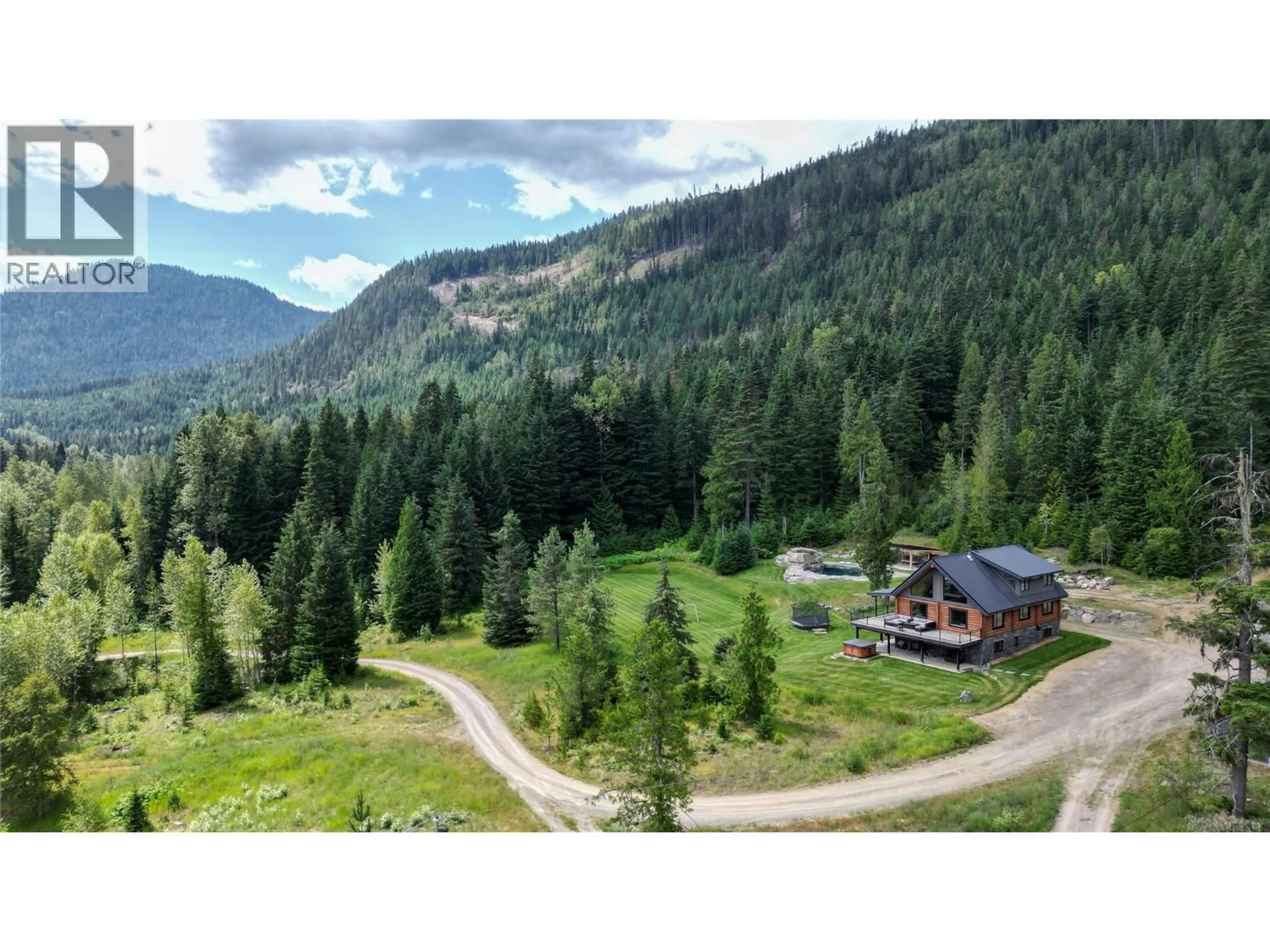 A pic from outside/outdoor area/front of a property/back of a property/a pic from drone, mountain view for 6580 HIGHWAY 6 OTHER, Ymir British Columbia V0G2K0