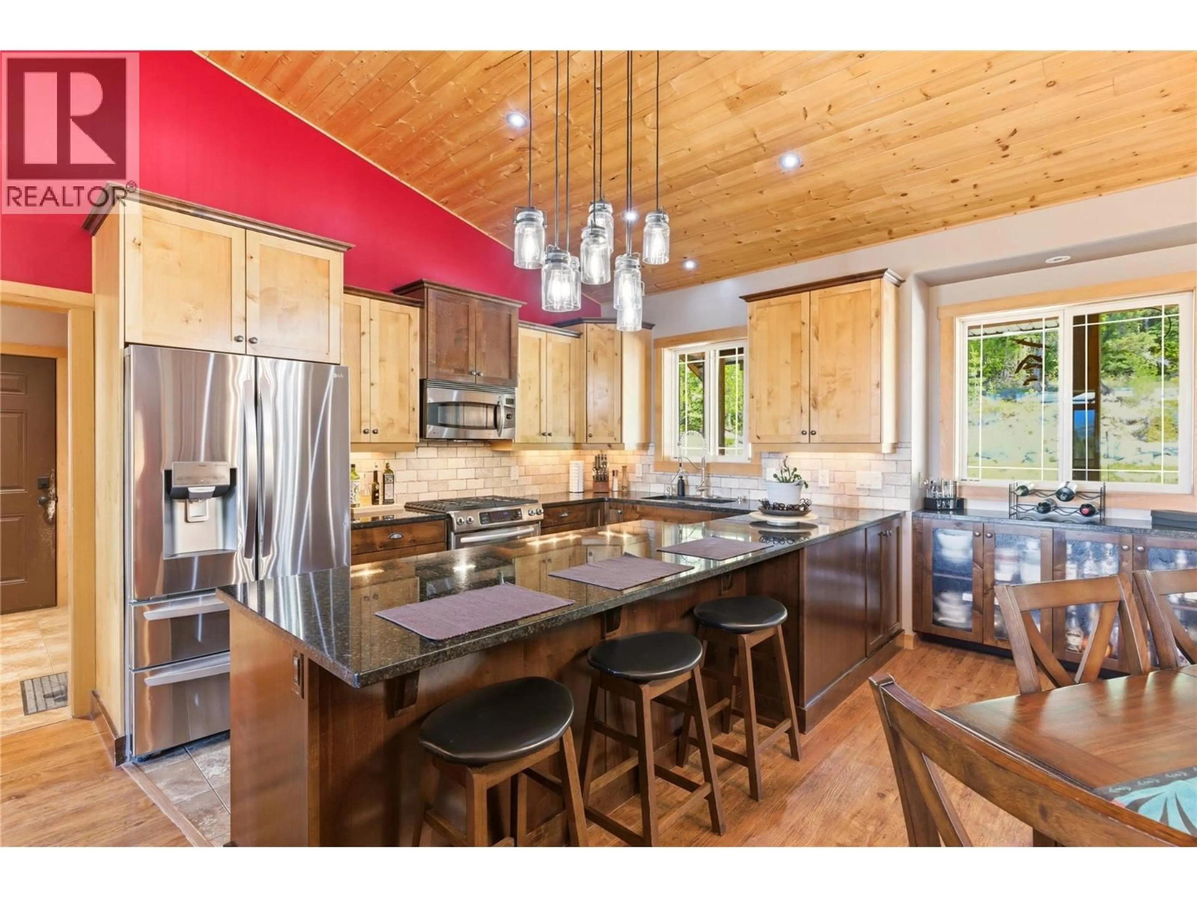 Open concept kitchen, wood/laminate floor for 7080 SUN VALLEY ROAD, Kelowna British Columbia V1P1H4