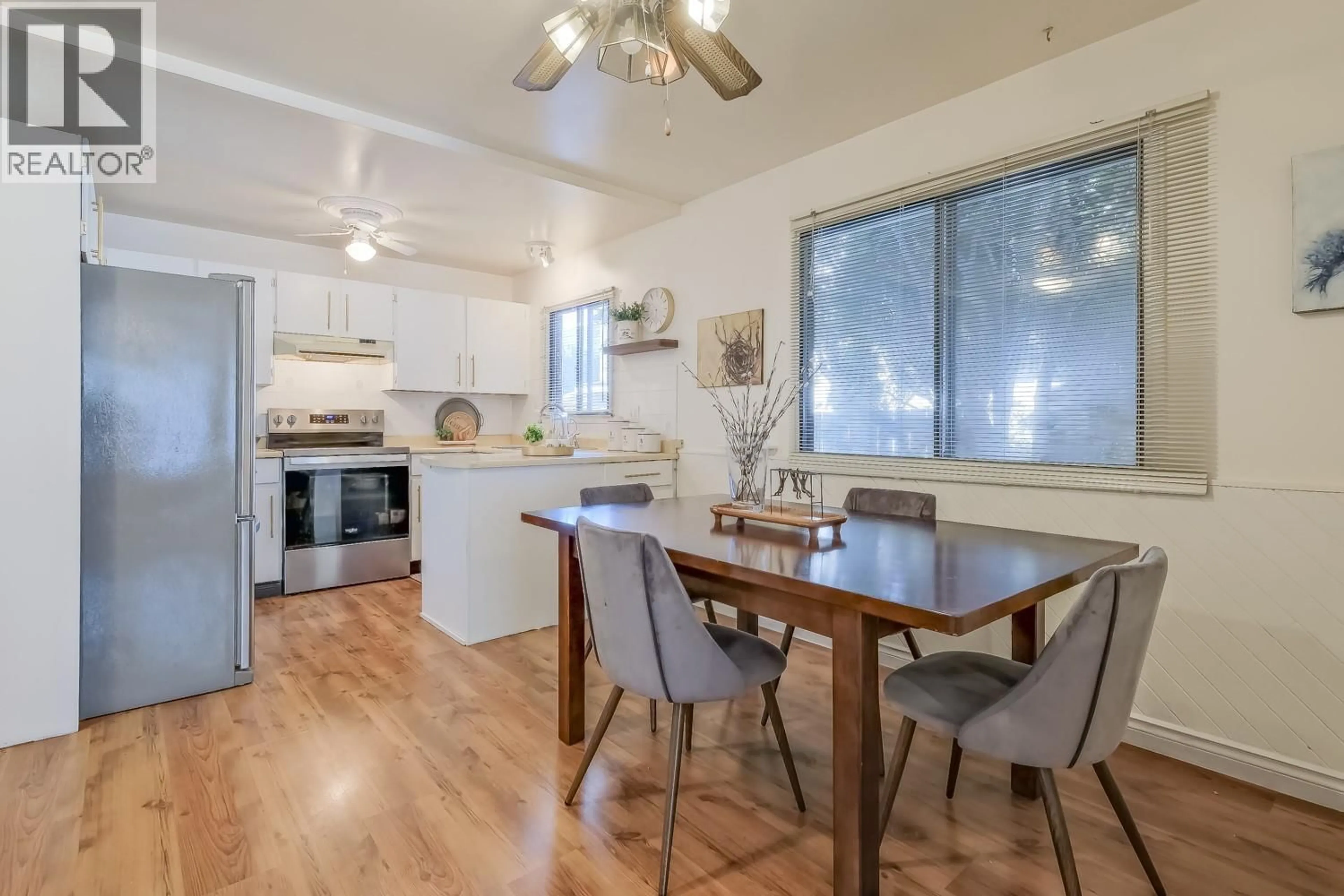 Open concept kitchen, wood/laminate floor for 182 BLAIRMORE CRESCENT, Penticton British Columbia V2A7C5