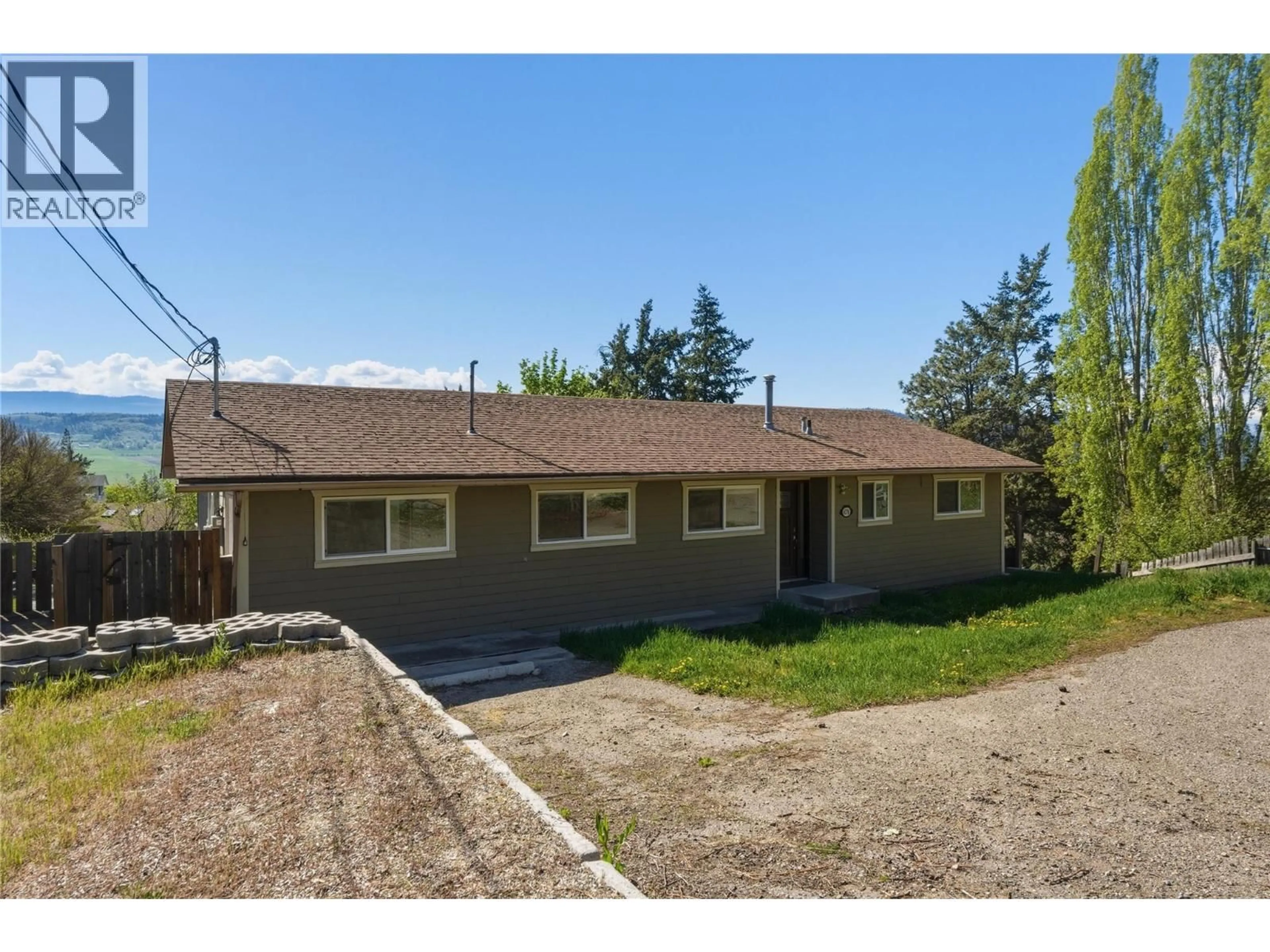 A pic from outside/outdoor area/front of a property/back of a property/a pic from drone, street for 6576 SOUTHWIND ROAD ROAD, Vernon British Columbia V1H1B7