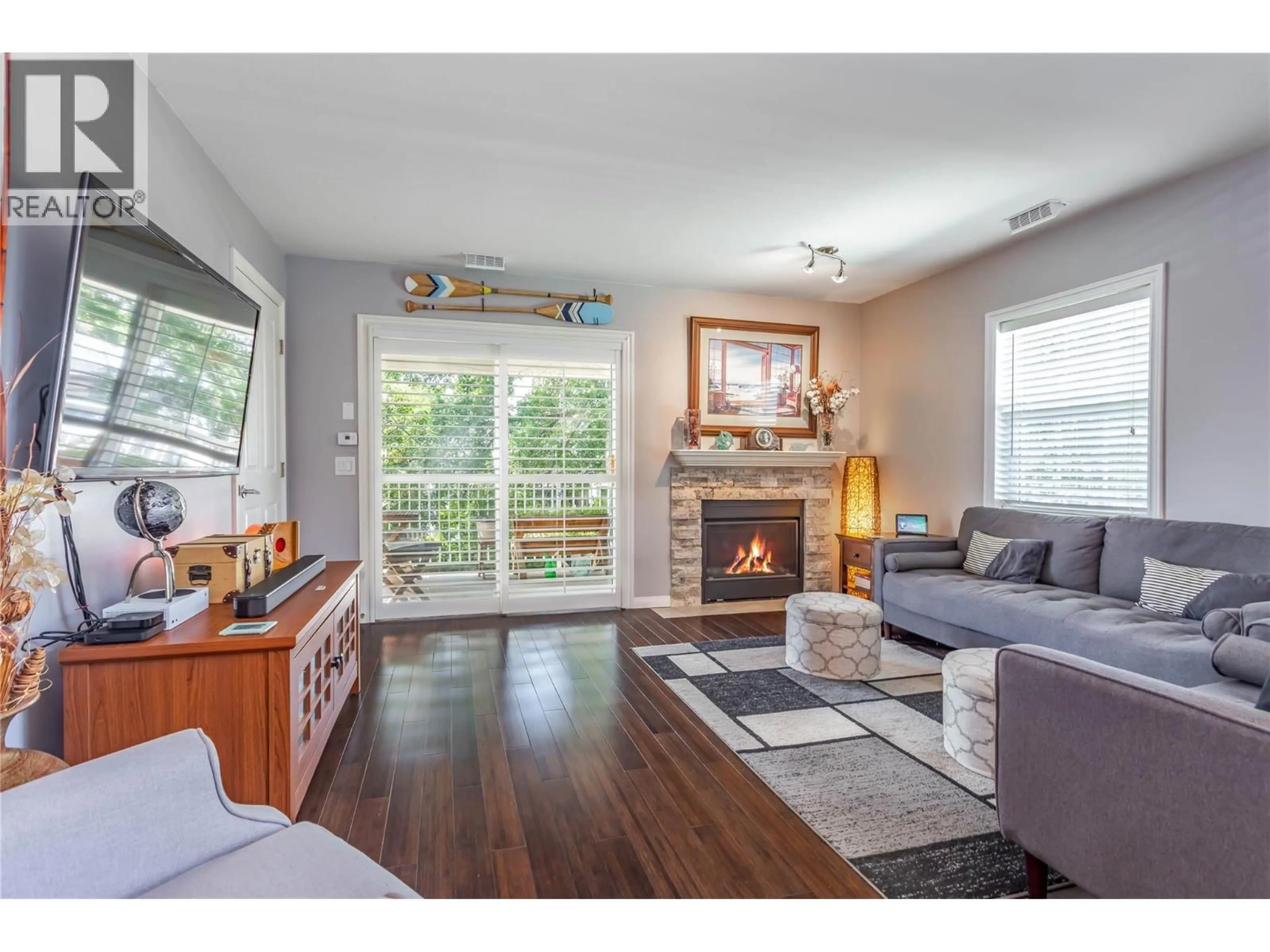 Living room with furniture, wood/laminate floor for 218 - 2370 STILLINGFLEET ROAD, Kelowna British Columbia V1W3X8