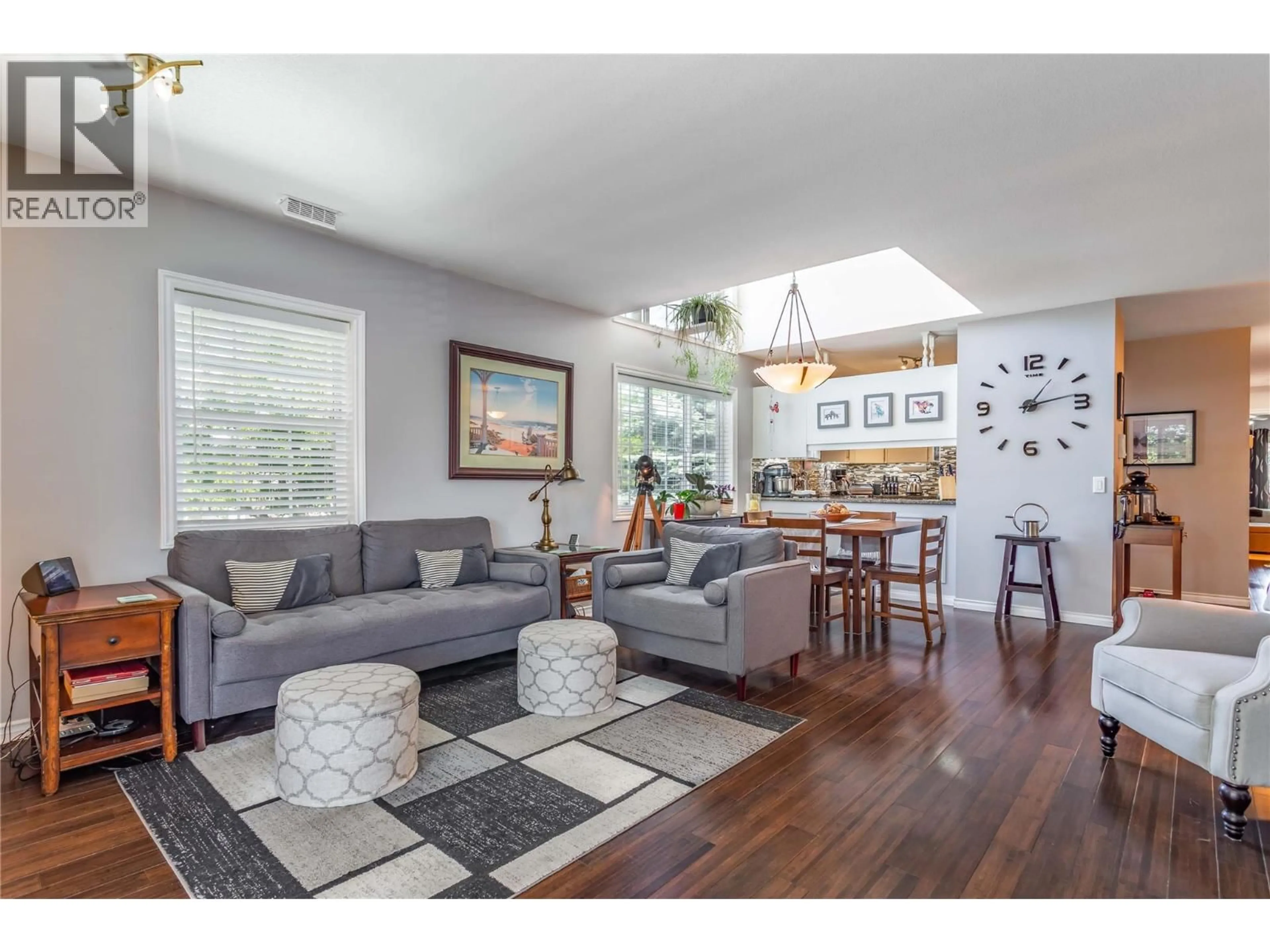Living room with furniture, wood/laminate floor for 218 - 2370 STILLINGFLEET ROAD, Kelowna British Columbia V1W3X8
