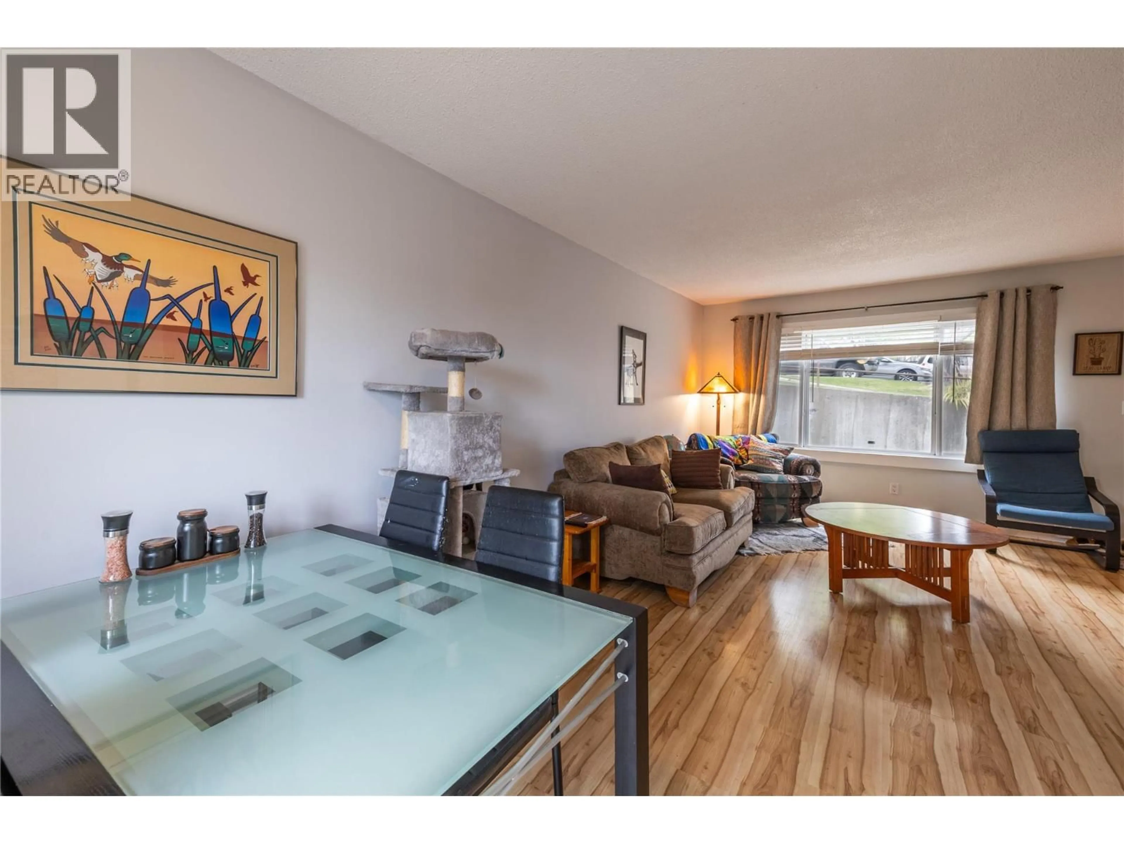 Living room with furniture, wood/laminate floor for 75 - 1605 SUMMIT DRIVE, Kamloops British Columbia V2E2A5