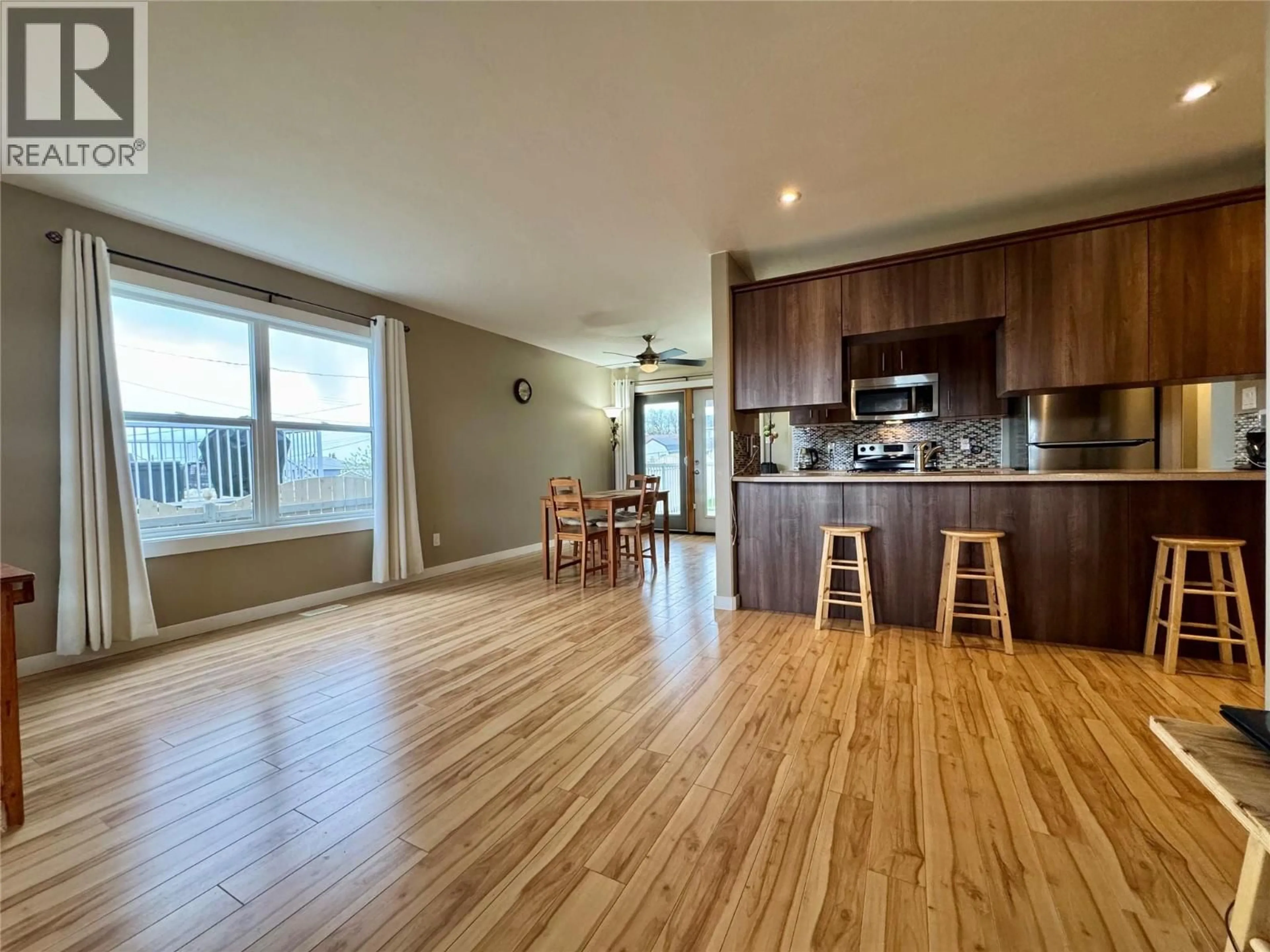 Open concept kitchen, wood/laminate floor for 704 99 AVENUE, Dawson Creek British Columbia V1G1T4