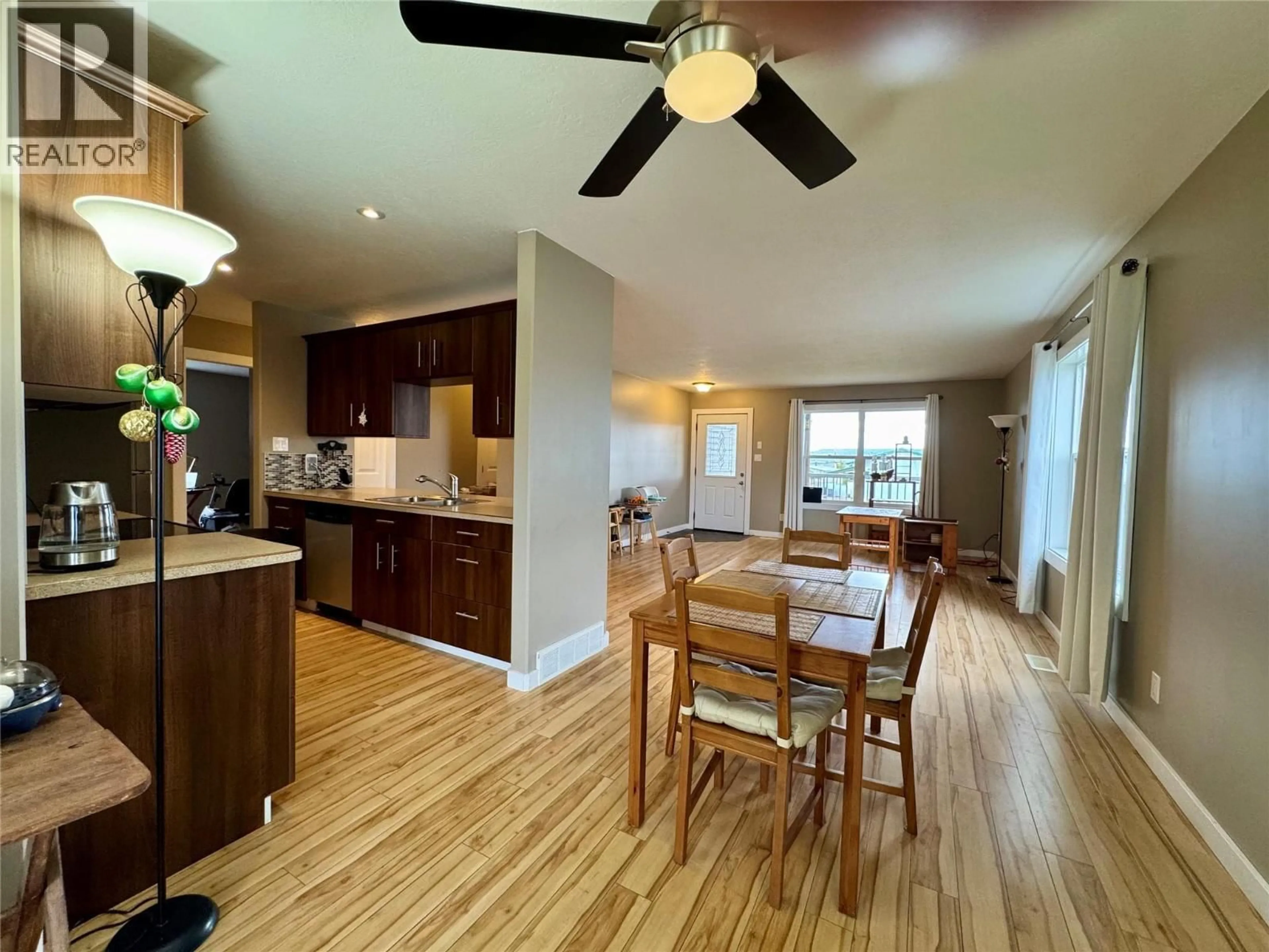 Open concept kitchen, wood/laminate floor for 704 99 AVENUE, Dawson Creek British Columbia V1G1T4