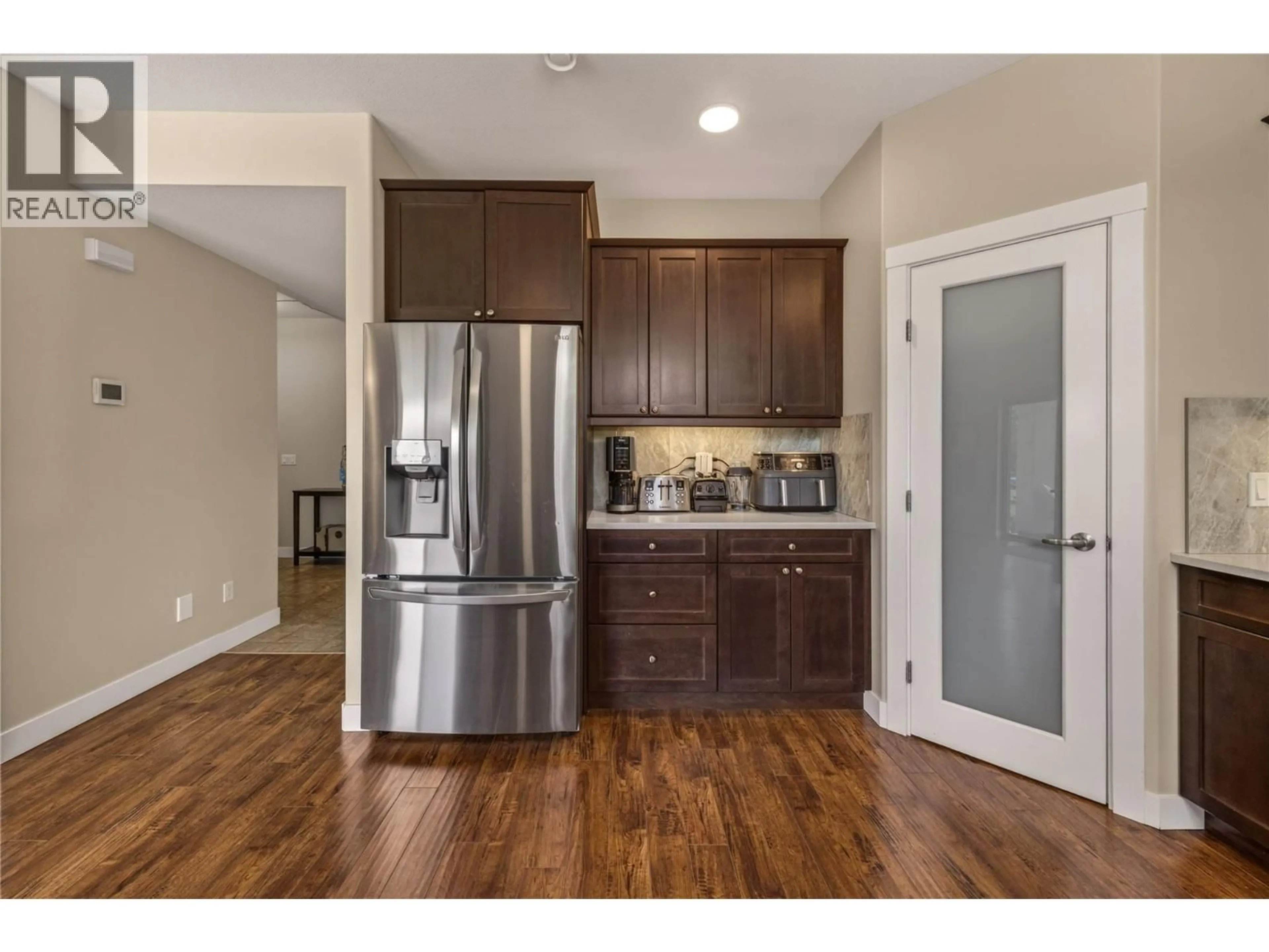 Open concept kitchen, wood/laminate floor for 1699 TREFFRY PLACE, Summerland British Columbia V0H1Z9