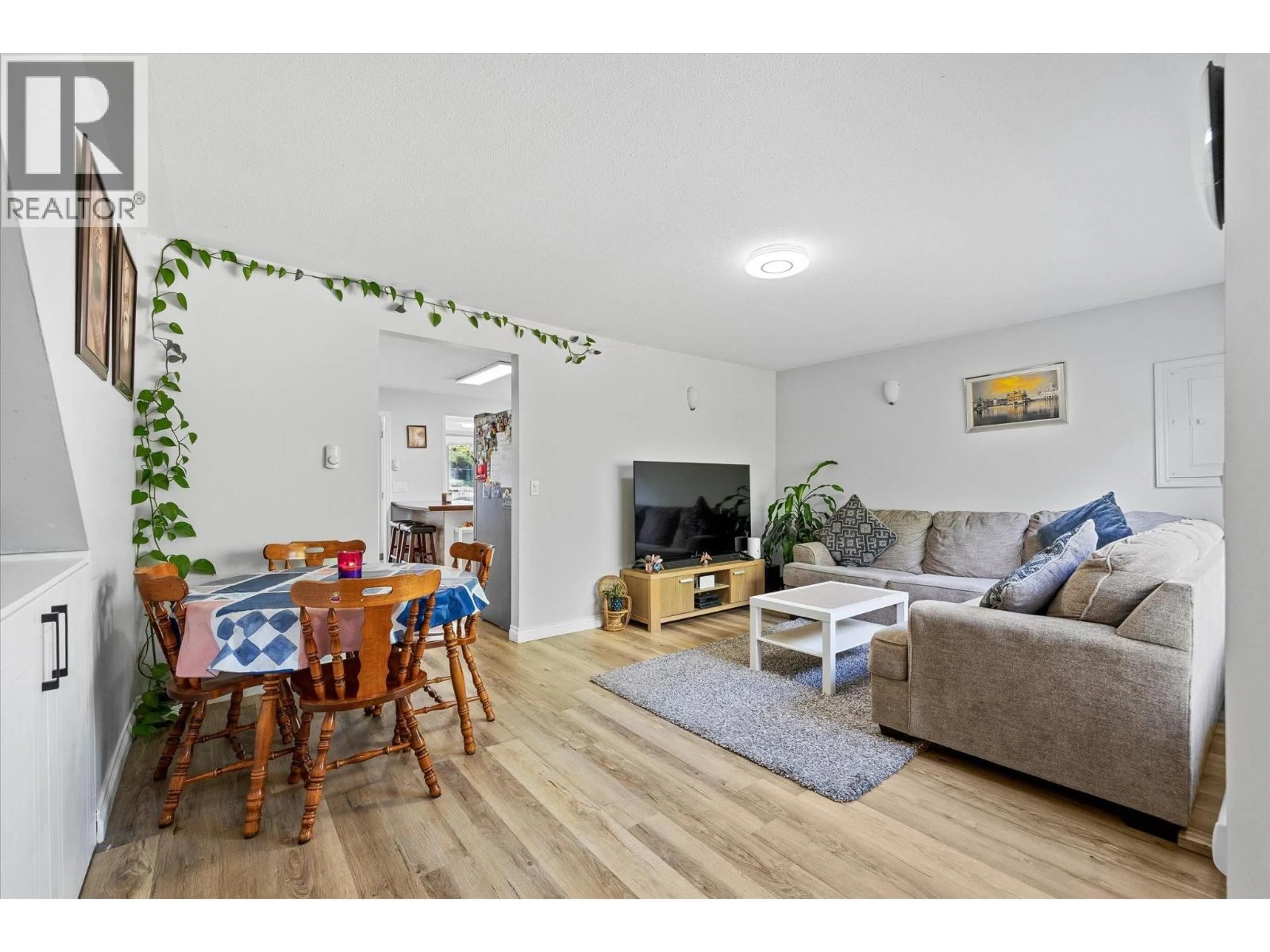 Living room with furniture, wood/laminate floor for 11592 OKANAGAN CENTRE ROAD EAST, Lake Country British Columbia V4V1G4
