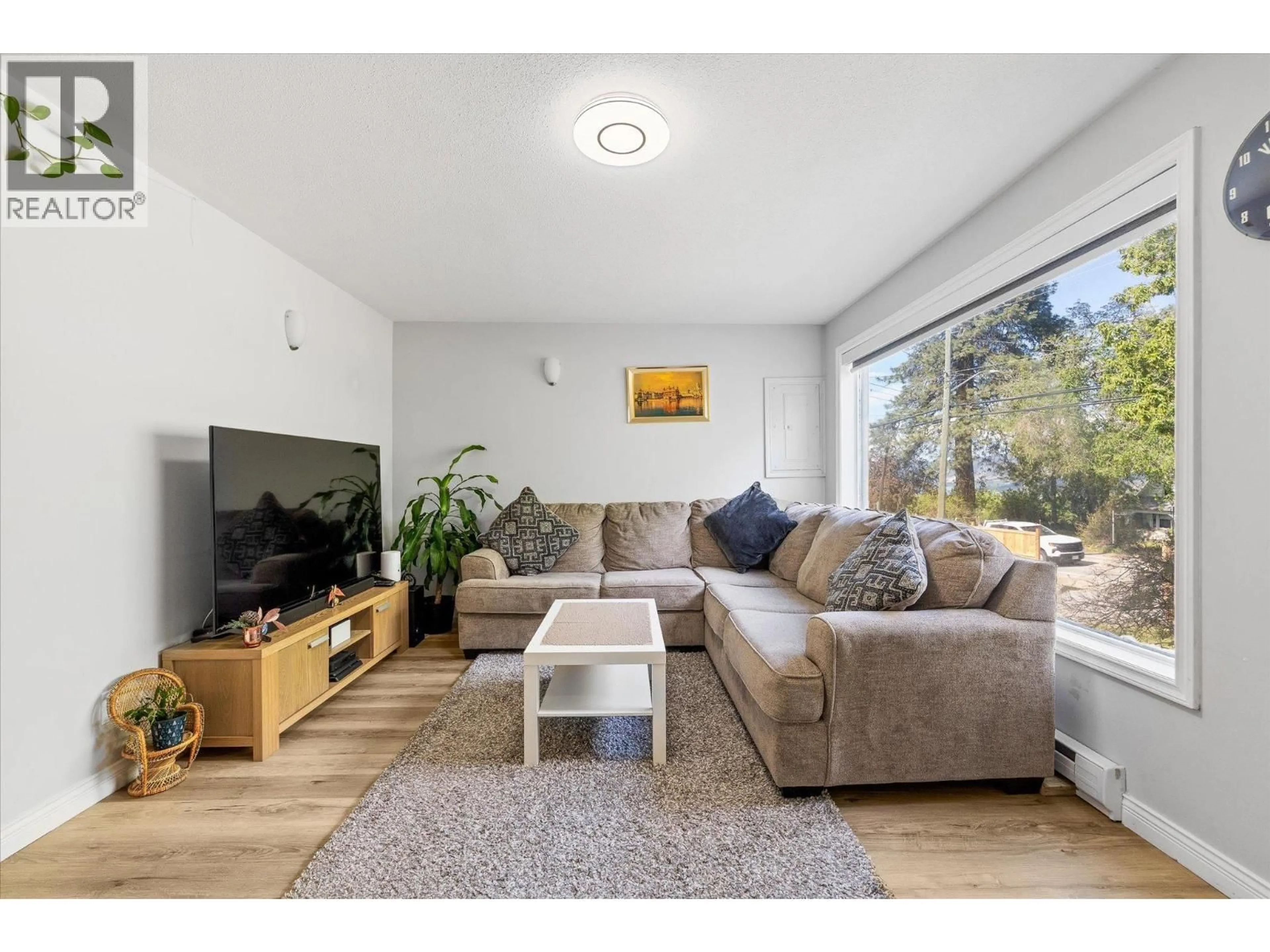 Living room with furniture, wood/laminate floor for 11592 OKANAGAN CENTRE ROAD EAST, Lake Country British Columbia V4V1G4