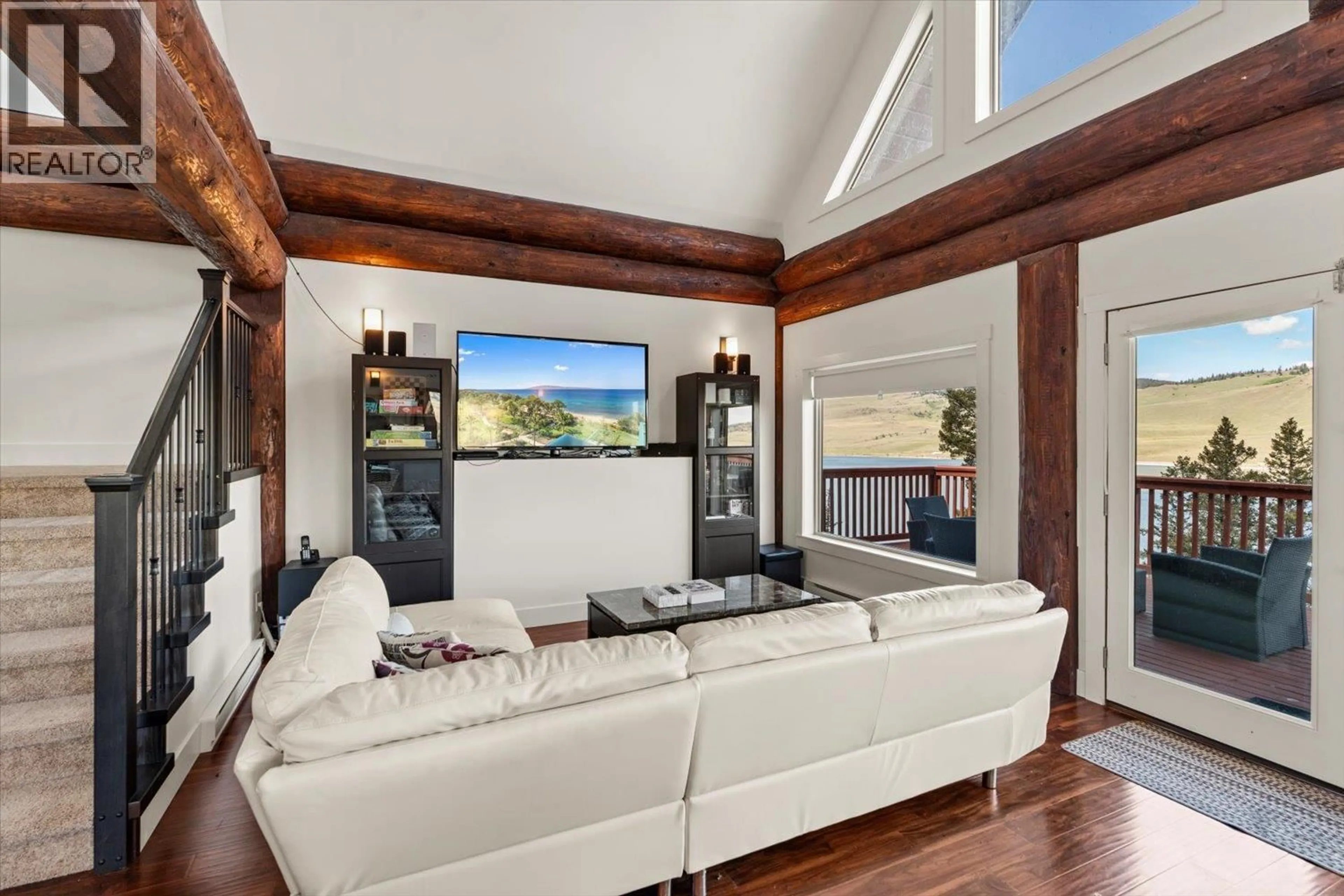 Living room with furniture, wood/laminate floor for 8605 OLD KAMLOOPS ROAD, Stump Lake British Columbia V0E2A0