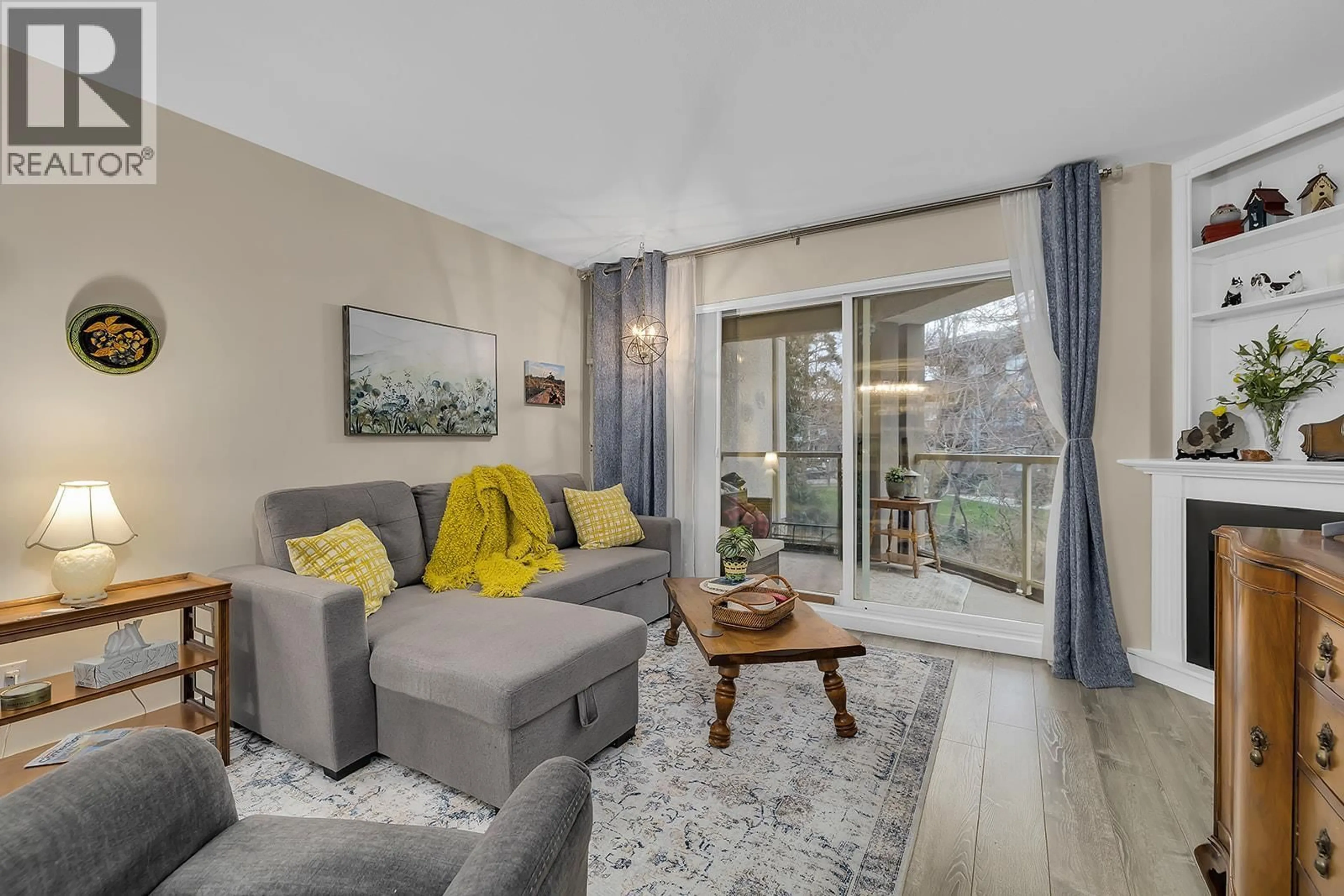 Living room with furniture, wood/laminate floor for 103 - 1965 PANDOSY STREET, Kelowna British Columbia V1Y1R9