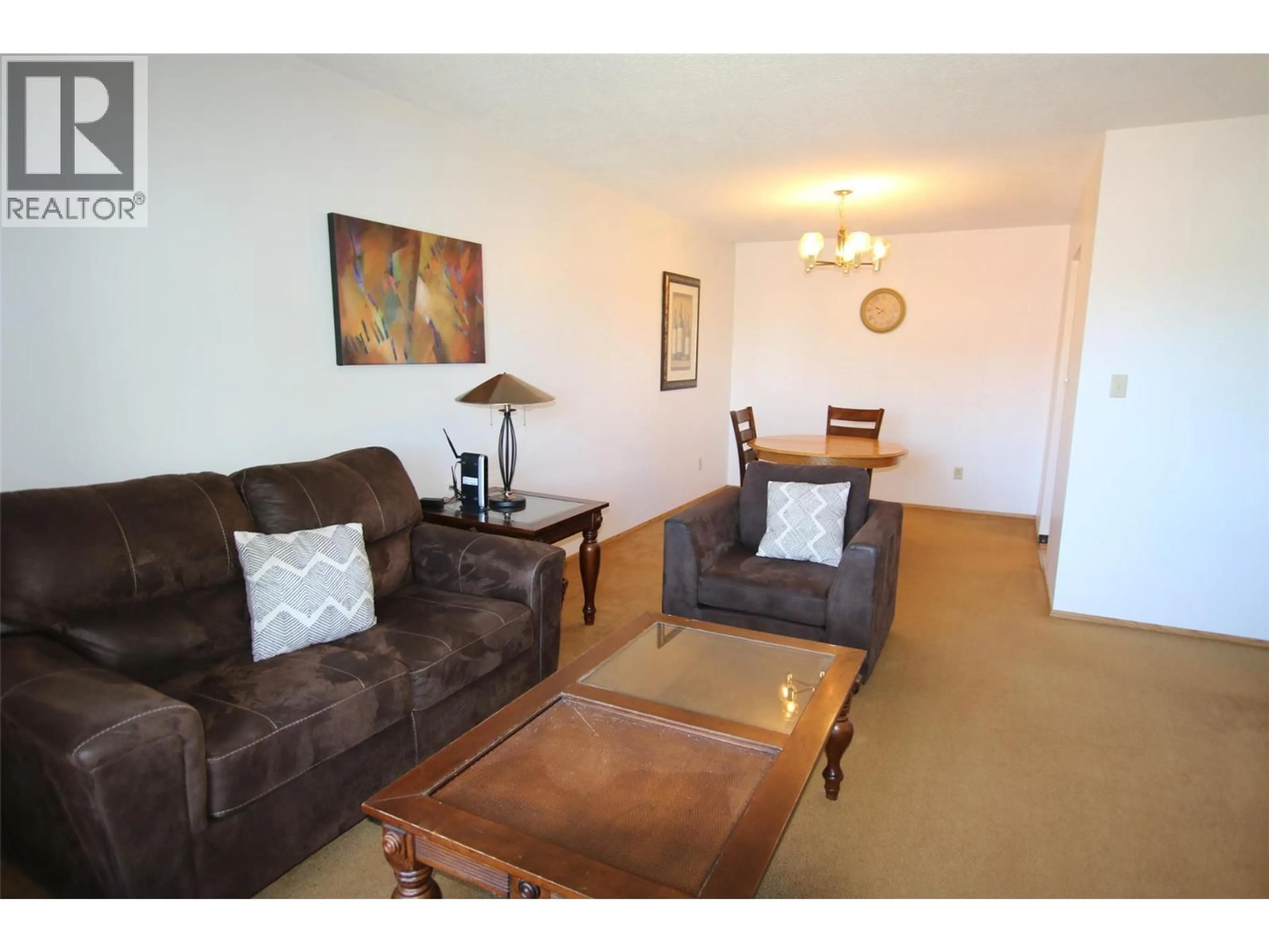 Living room with furniture, wood/laminate floor for 310 - 320 NORTHGATE ROAD, Tumbler Ridge British Columbia V0C2W0