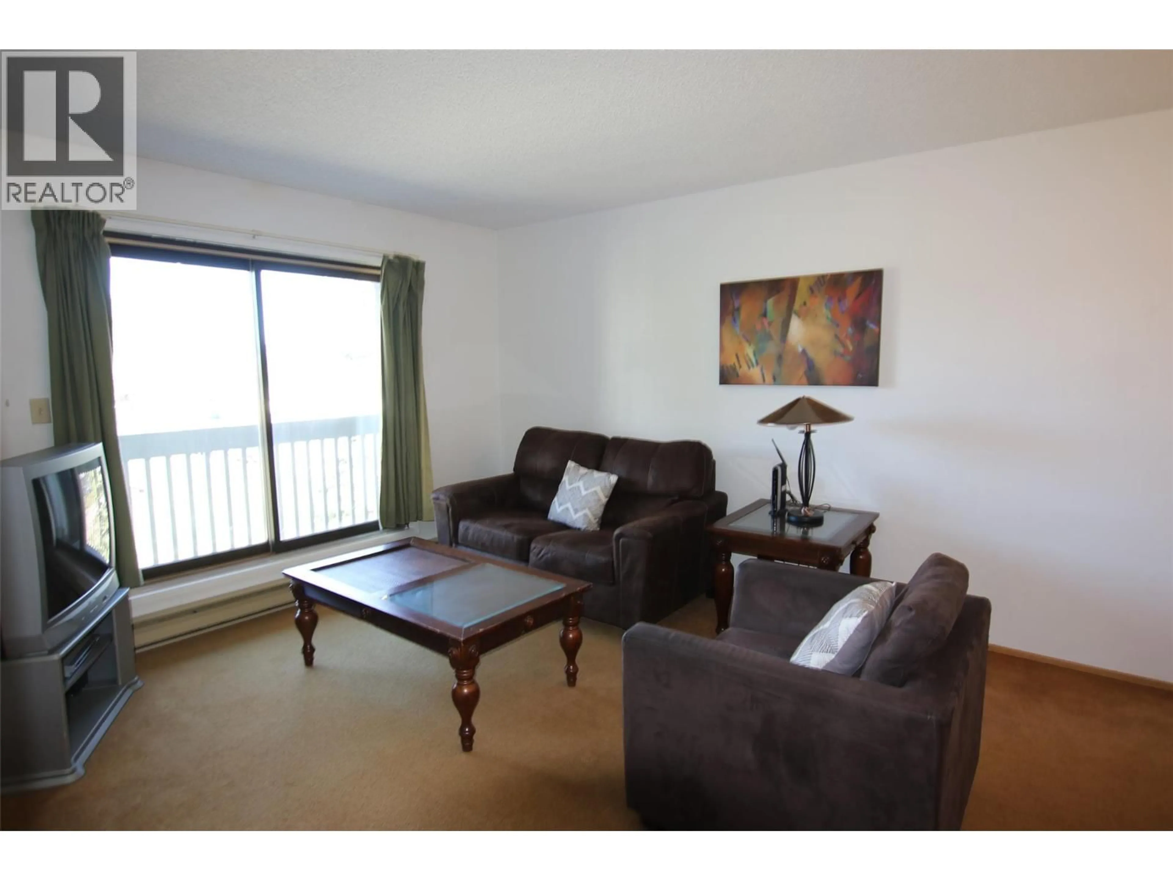 Living room with furniture, wood/laminate floor for 310 - 320 NORTHGATE ROAD, Tumbler Ridge British Columbia V0C2W0