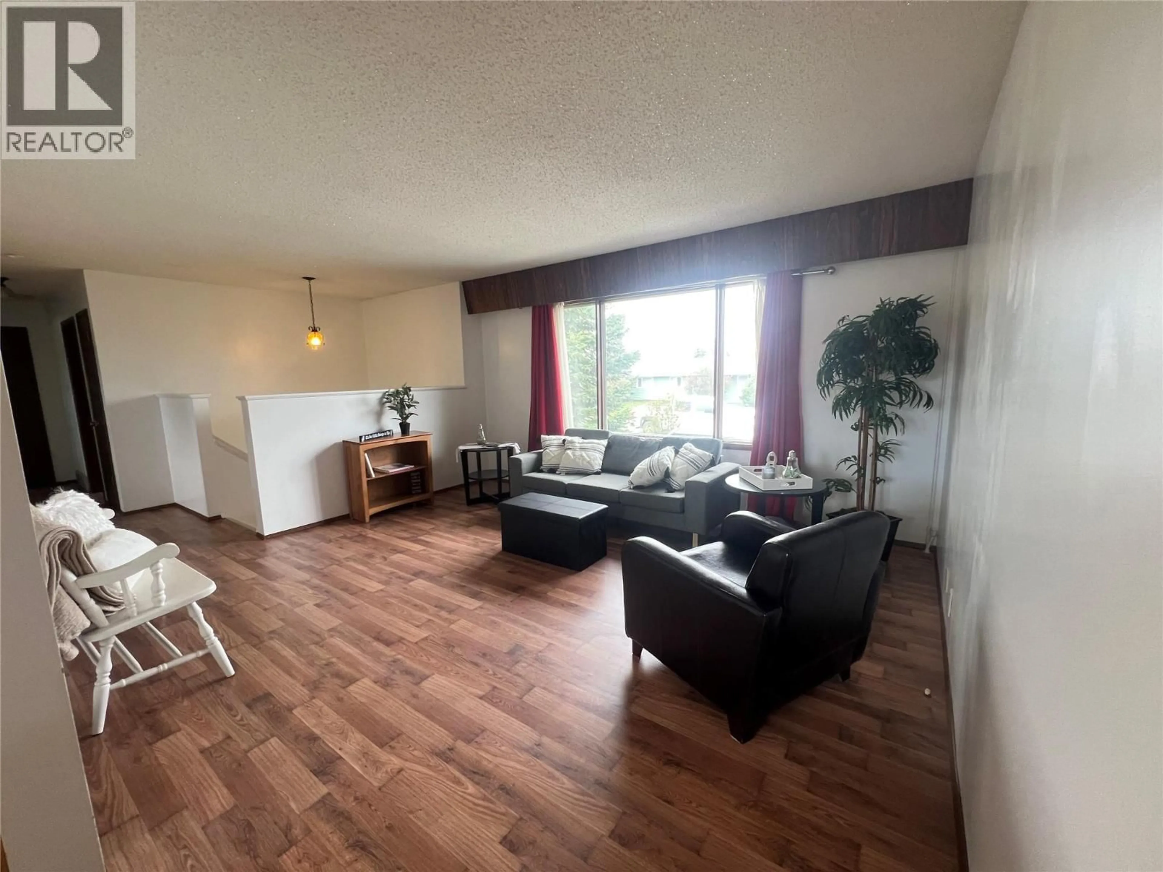 Living room with furniture, wood/laminate floor for 1029 118 AVENUE, Dawson Creek British Columbia V1G3H4