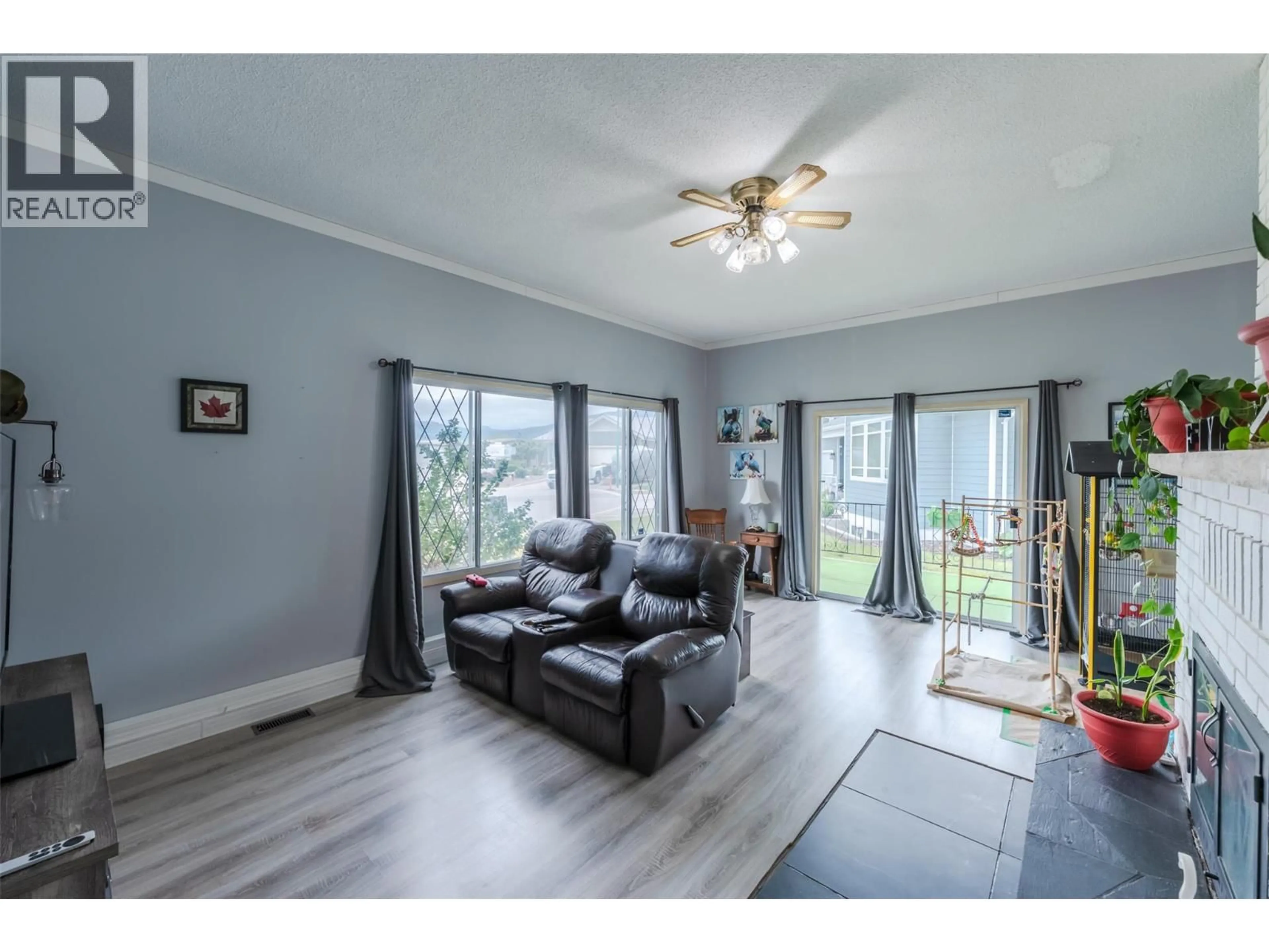 Living room with furniture, wood/laminate floor for 7503 HOWIS CRESCENT, Summerland British Columbia V0H1Z4