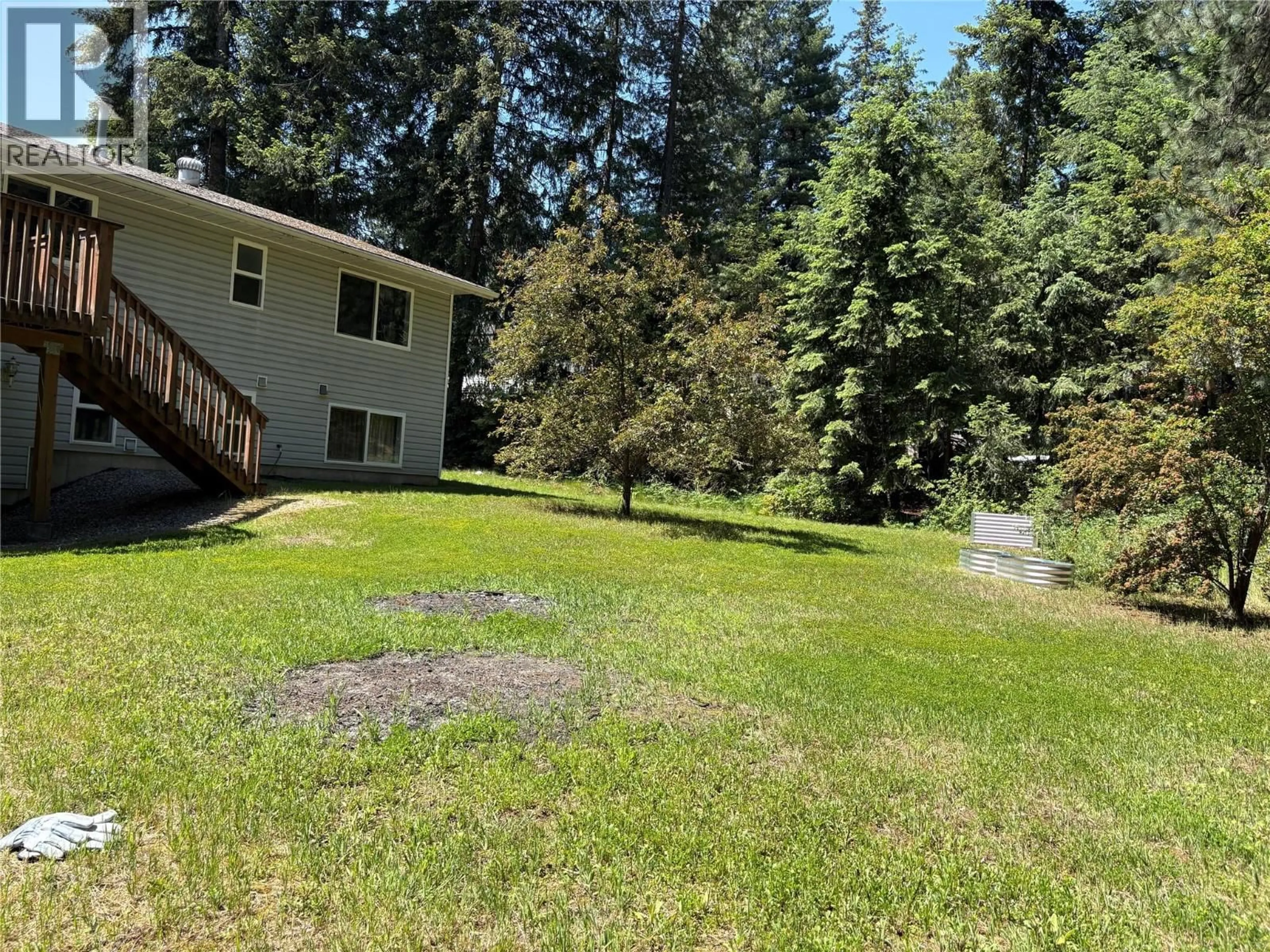 A pic from outside/outdoor area/front of a property/back of a property/a pic from drone, forest/trees view for 945 PINE CRESCENT, Genelle British Columbia V0G1G0