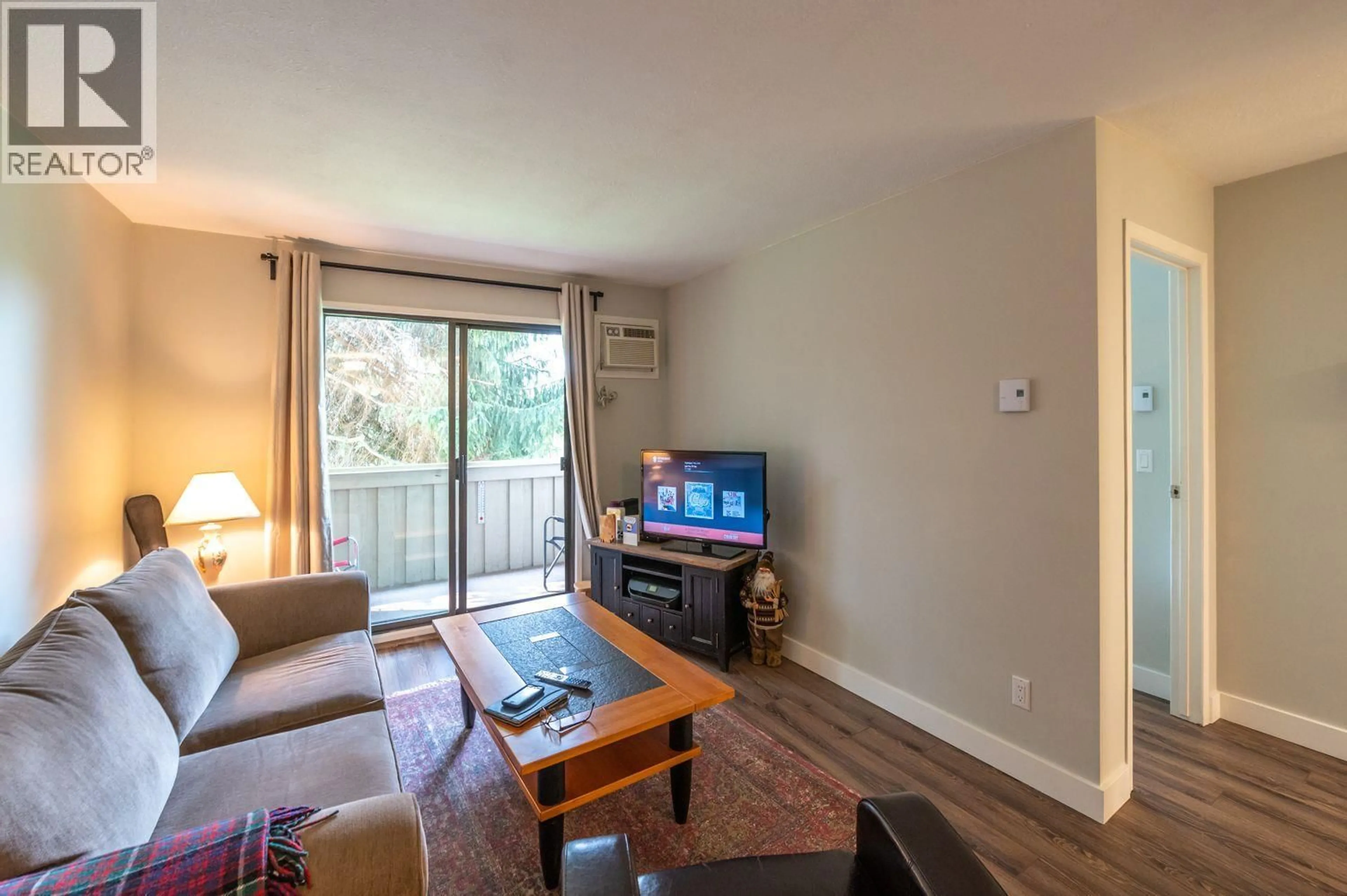 Living room with furniture, wood/laminate floor for 201 - 150 SKAHA PLACE, Penticton British Columbia V2A7K1
