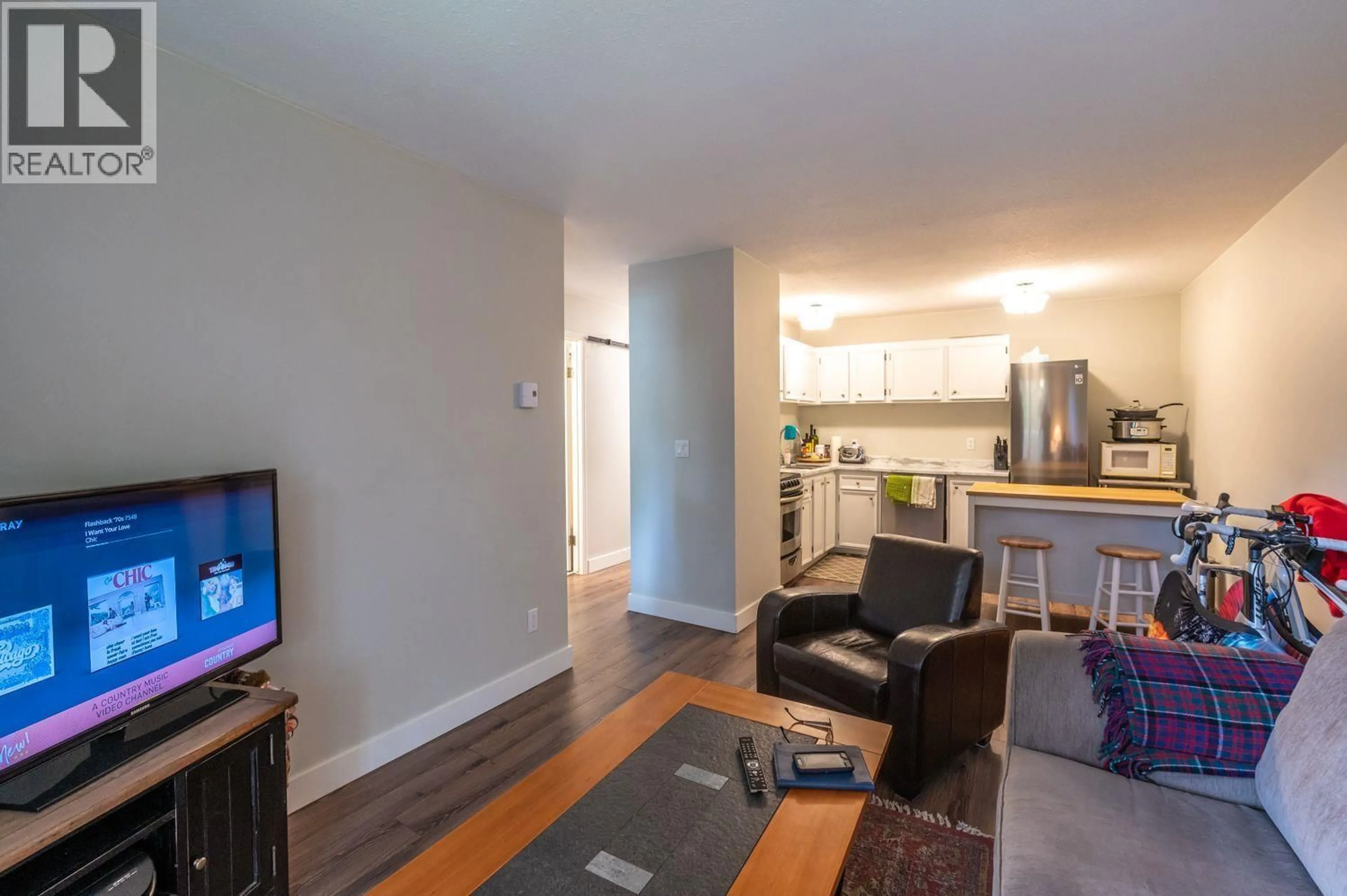 Living room with furniture, wood/laminate floor for 201 - 150 SKAHA PLACE, Penticton British Columbia V2A7K1