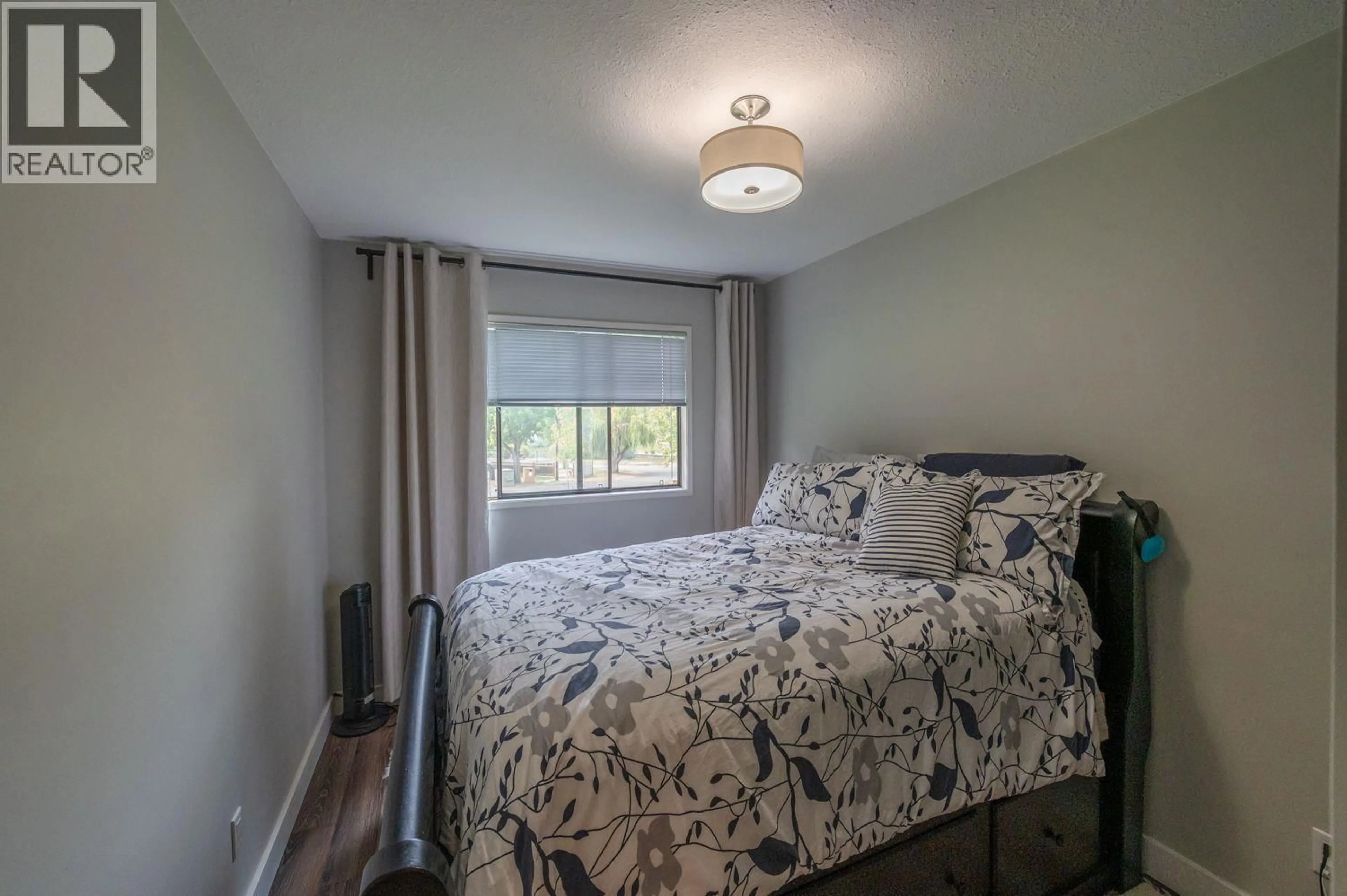 Bedroom with bed, wood/laminate floor for 201 - 150 SKAHA PLACE, Penticton British Columbia V2A7K1