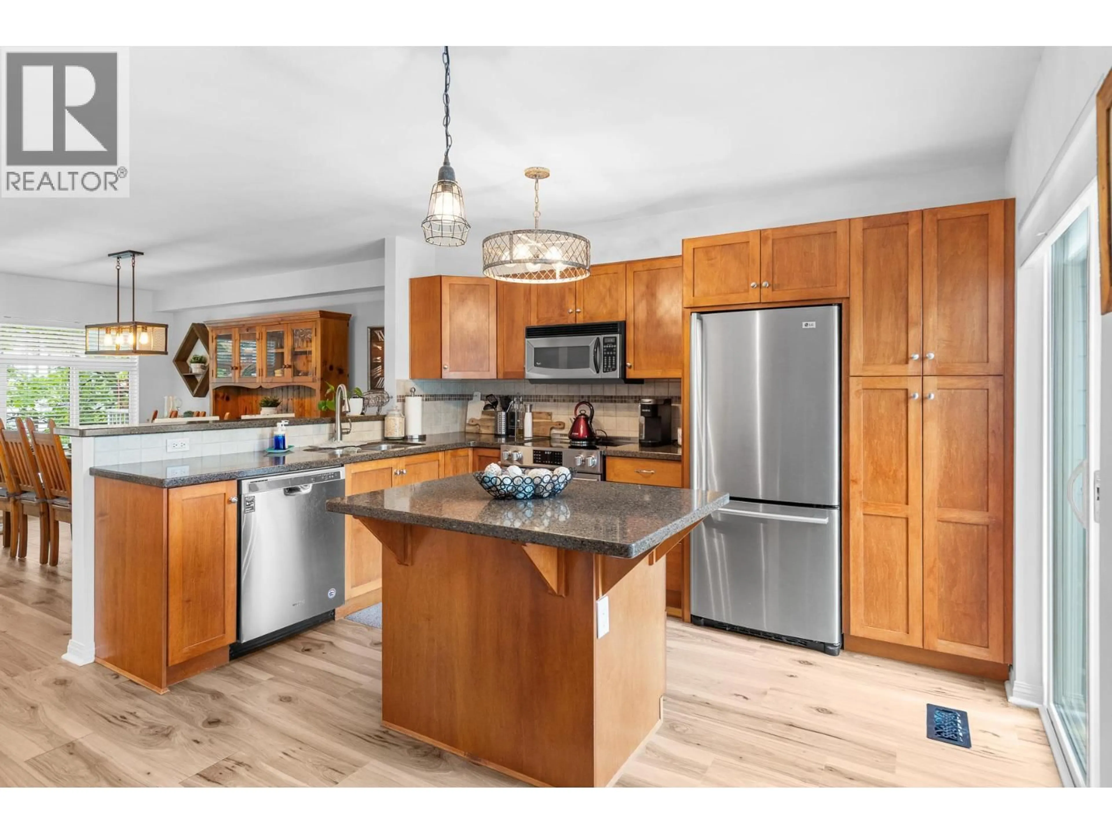 Open concept kitchen, wood/laminate floor for 8 - 1853 PARKVIEW CRESCENT, Kelowna British Columbia V1X8A3