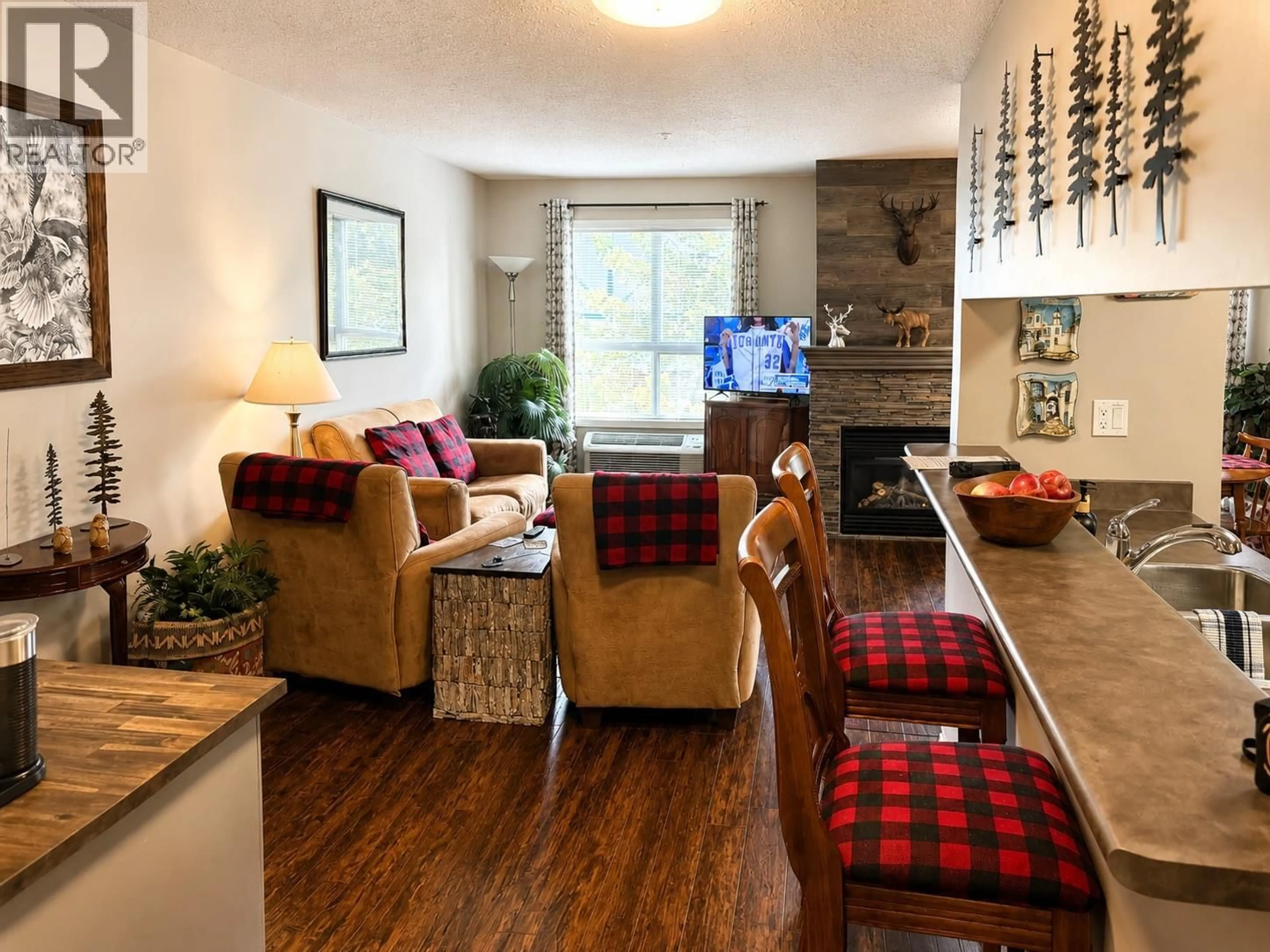 Living room with furniture, wood/laminate floor for 201 - 4765 FORSTERS LANDING ROAD, Radium Hot Springs British Columbia V0A1M0