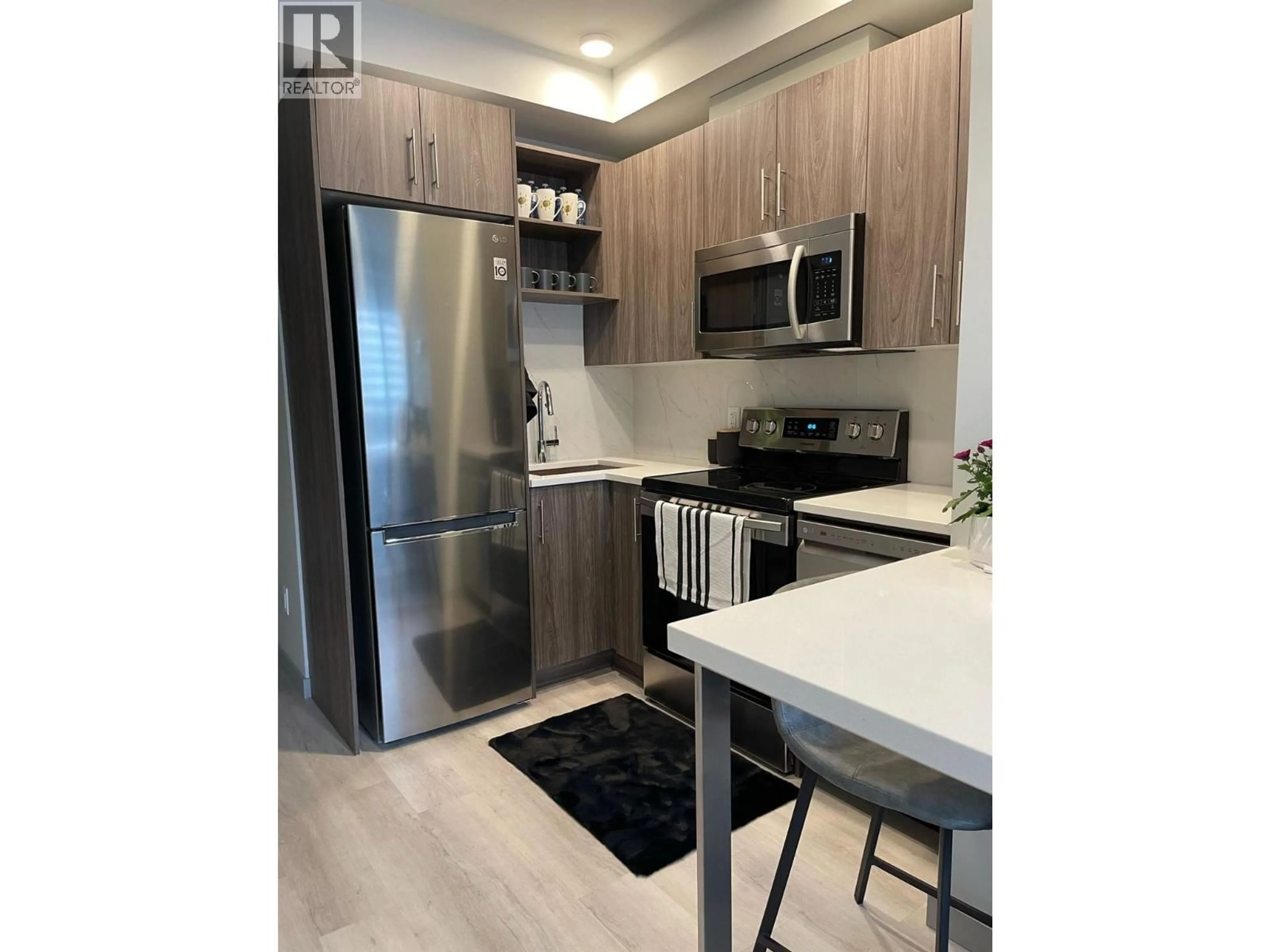 Open concept kitchen, wood/laminate floor for 215 - 345 DOUGALL ROAD NORTH, Kelowna British Columbia V1X3K8