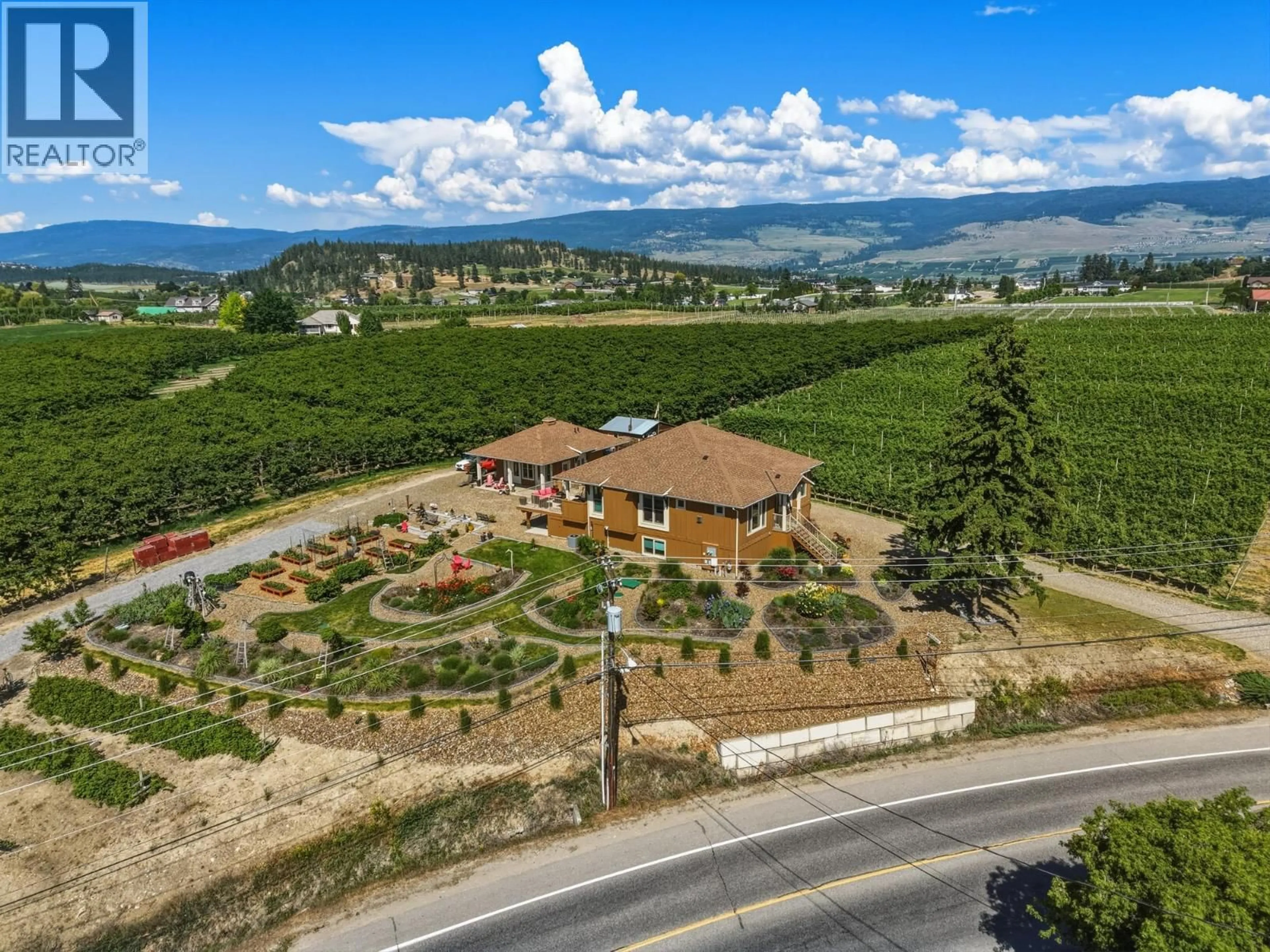 A pic from outside/outdoor area/front of a property/back of a property/a pic from drone, mountain view for 2400 LONGHILL ROAD, Kelowna British Columbia V1V2G3
