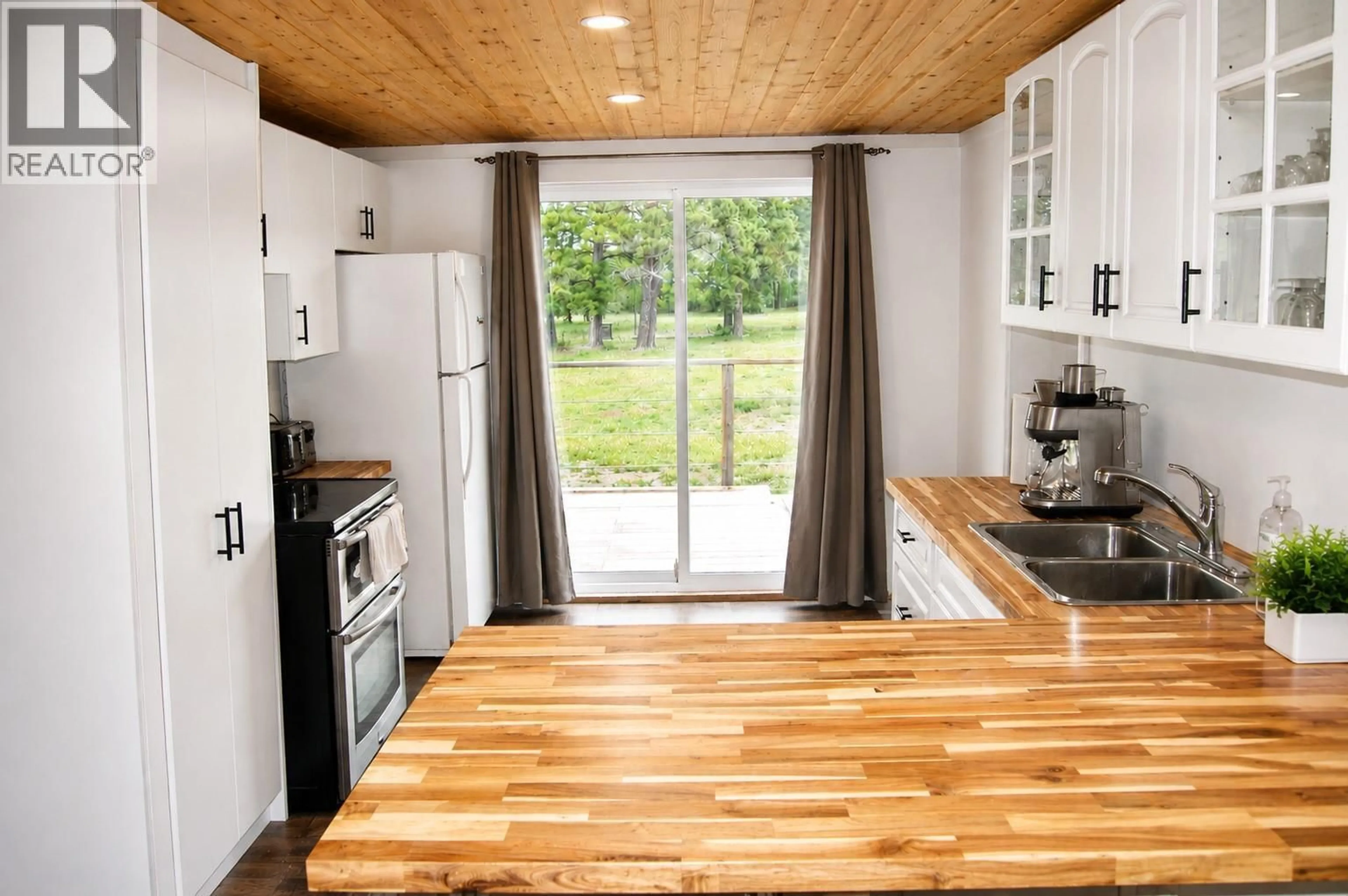 Open concept kitchen, wood/laminate floor for 5553 93/95 HIGHWAY, Ta Ta Creek British Columbia V0B2E0