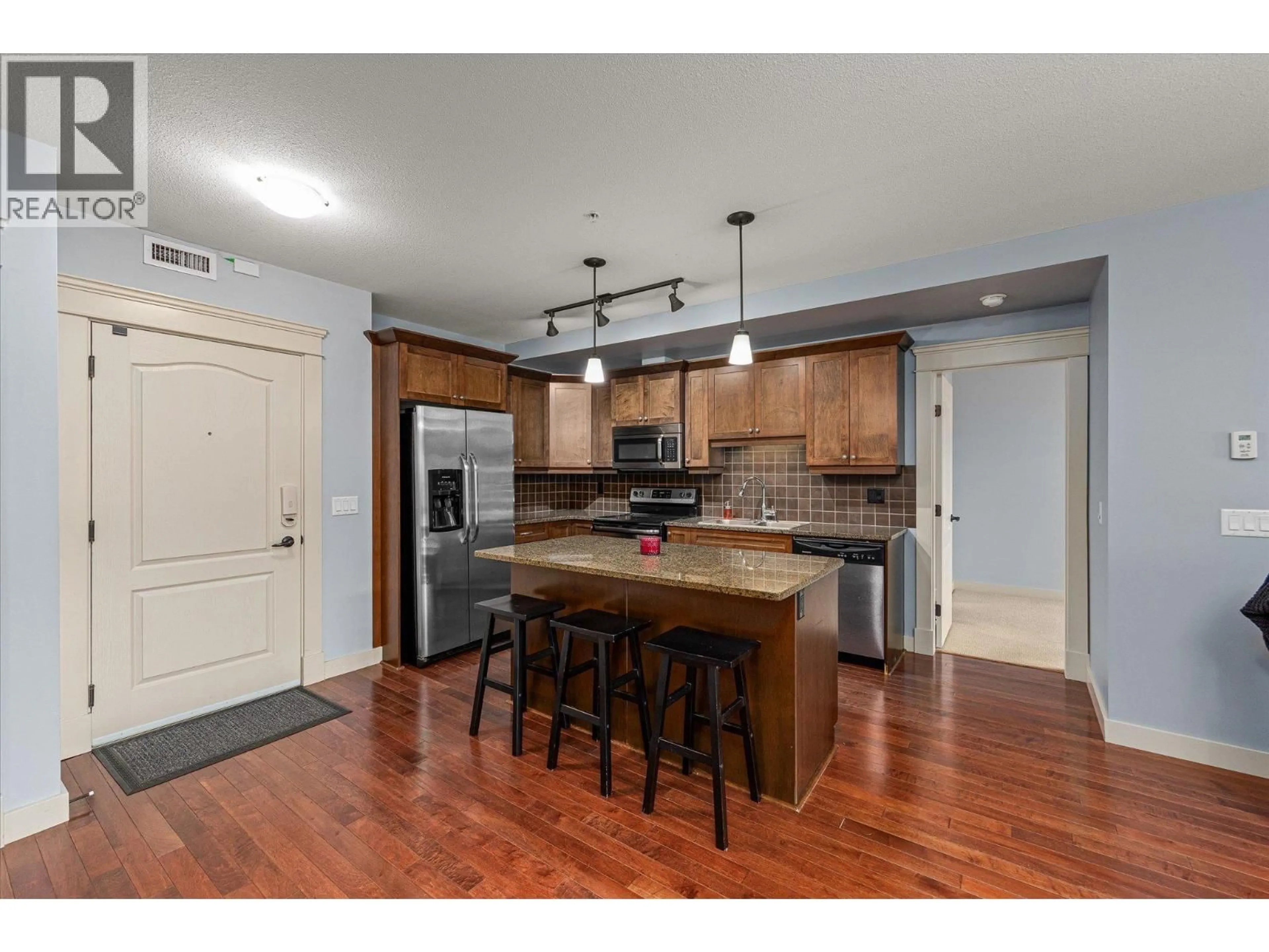 Open concept kitchen, wood/laminate floor for 402 - 2070 BOUCHERIE ROAD, West Kelowna British Columbia V4T3K9