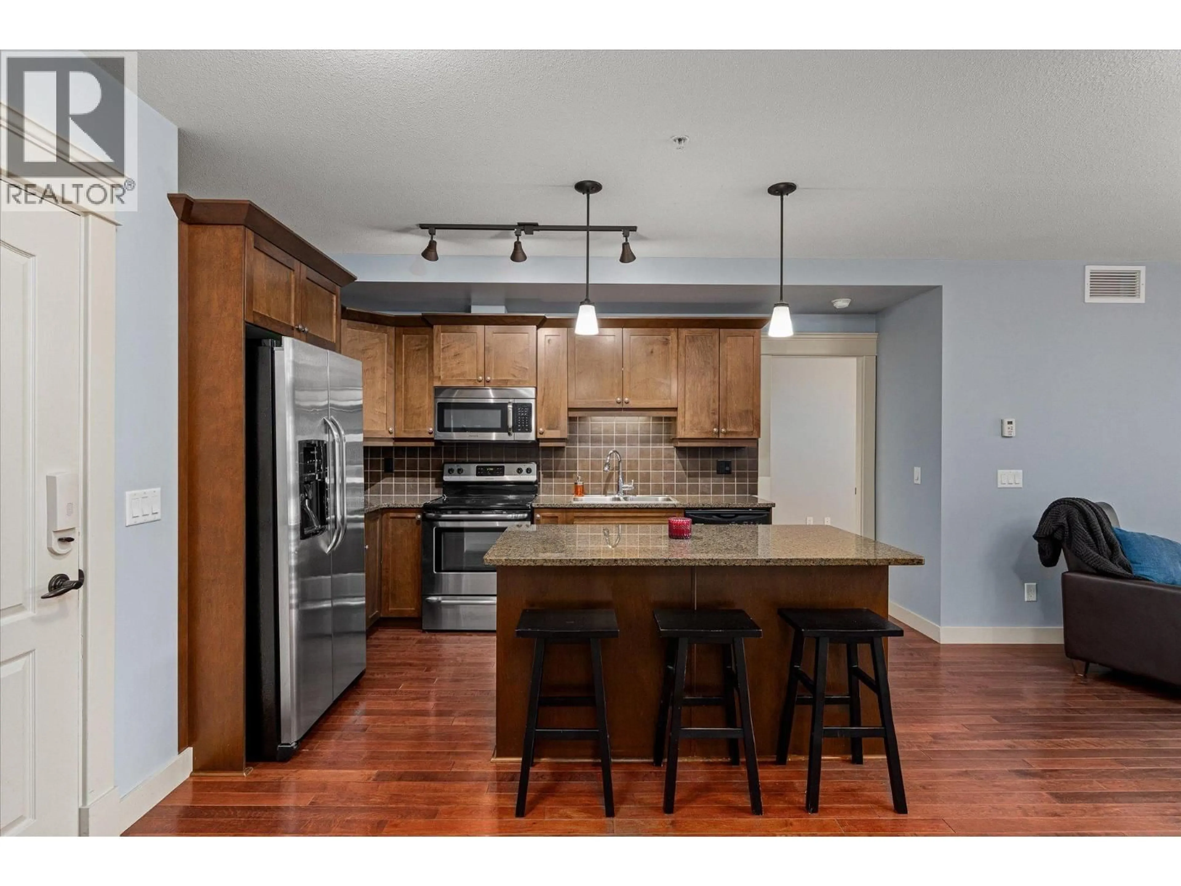 Open concept kitchen, wood/laminate floor for 402 - 2070 BOUCHERIE ROAD, West Kelowna British Columbia V4T3K9