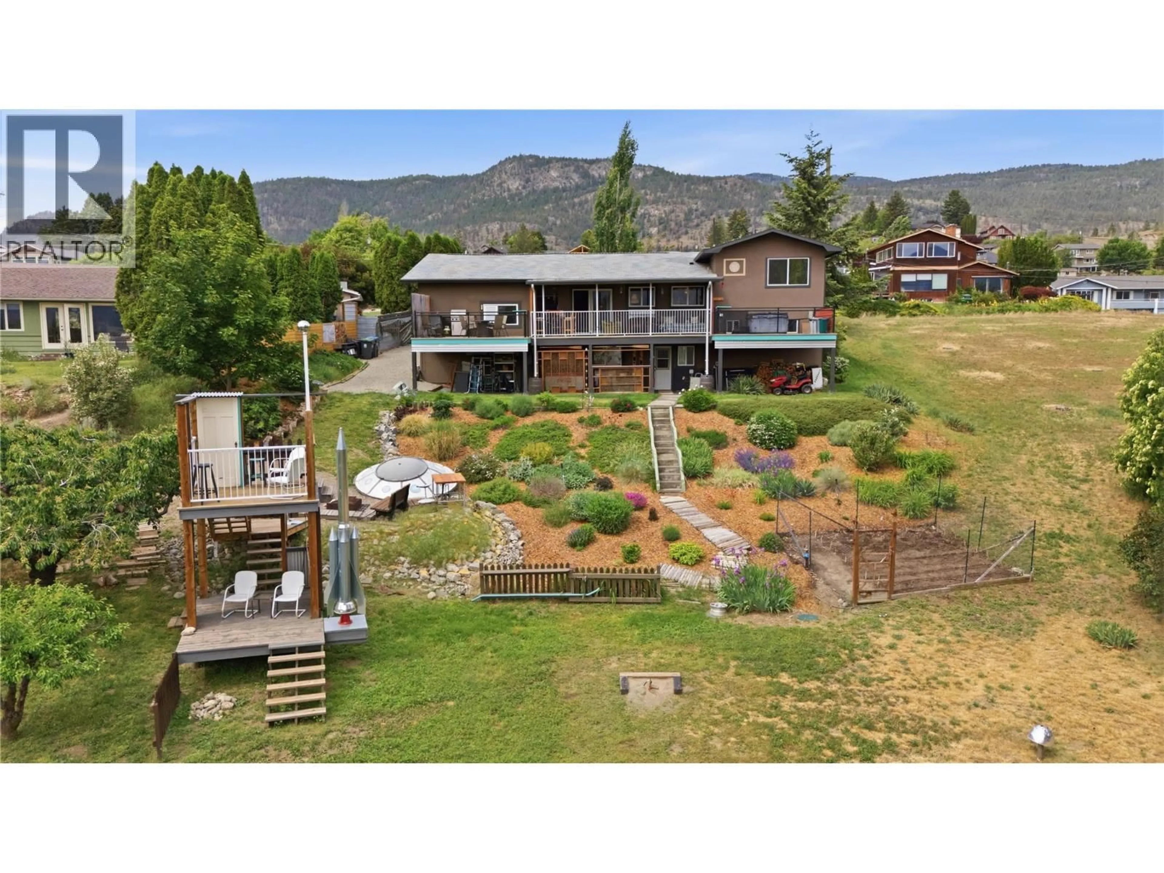 A pic from outside/outdoor area/front of a property/back of a property/a pic from drone, mountain view for 1019 VETERAN DRIVE, Penticton British Columbia V2A7K8
