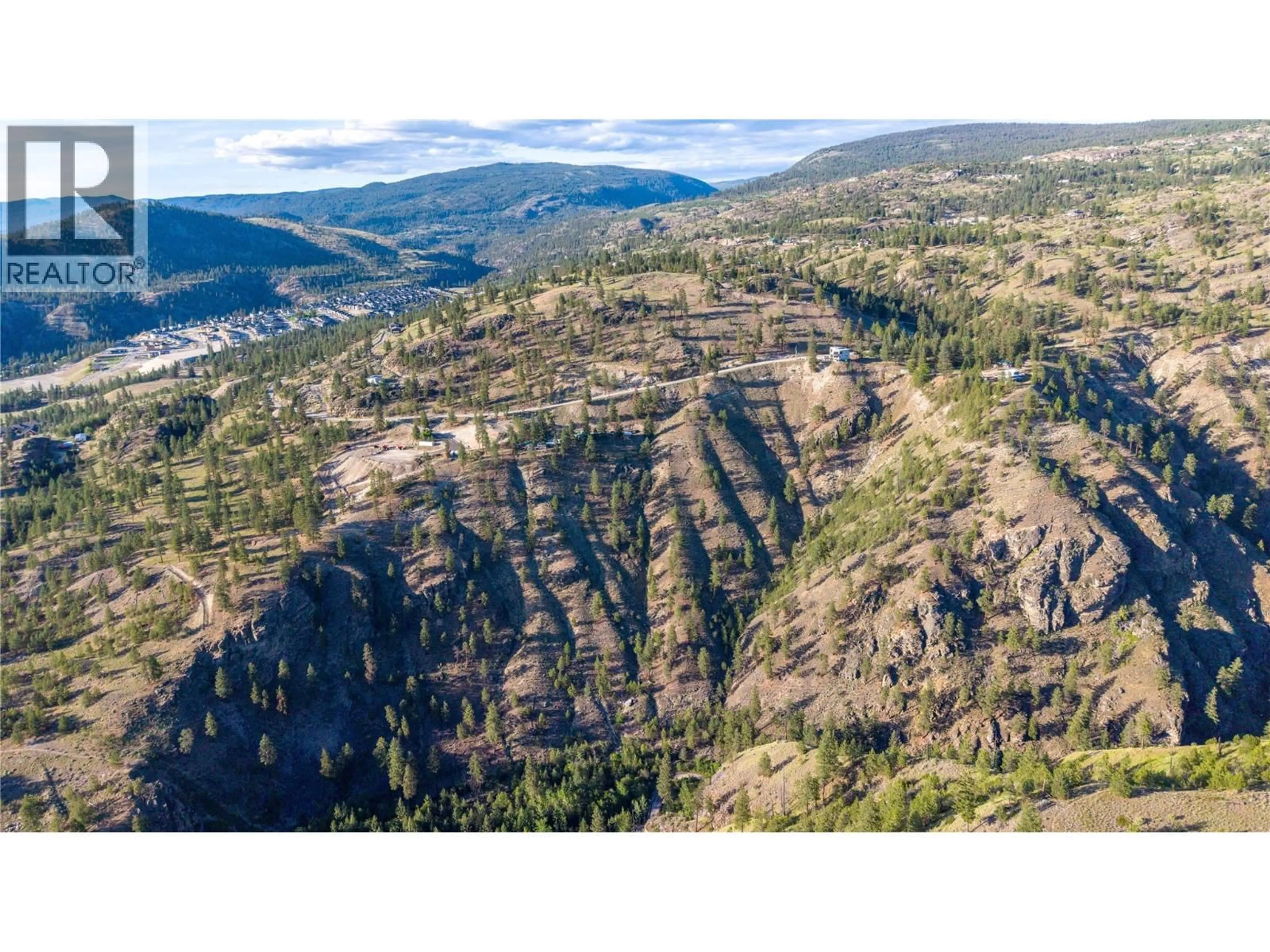A pic from outside/outdoor area/front of a property/back of a property/a pic from drone, mountain view for 158 SALIKEN DRIVE, Penticton British Columbia V2A8V6