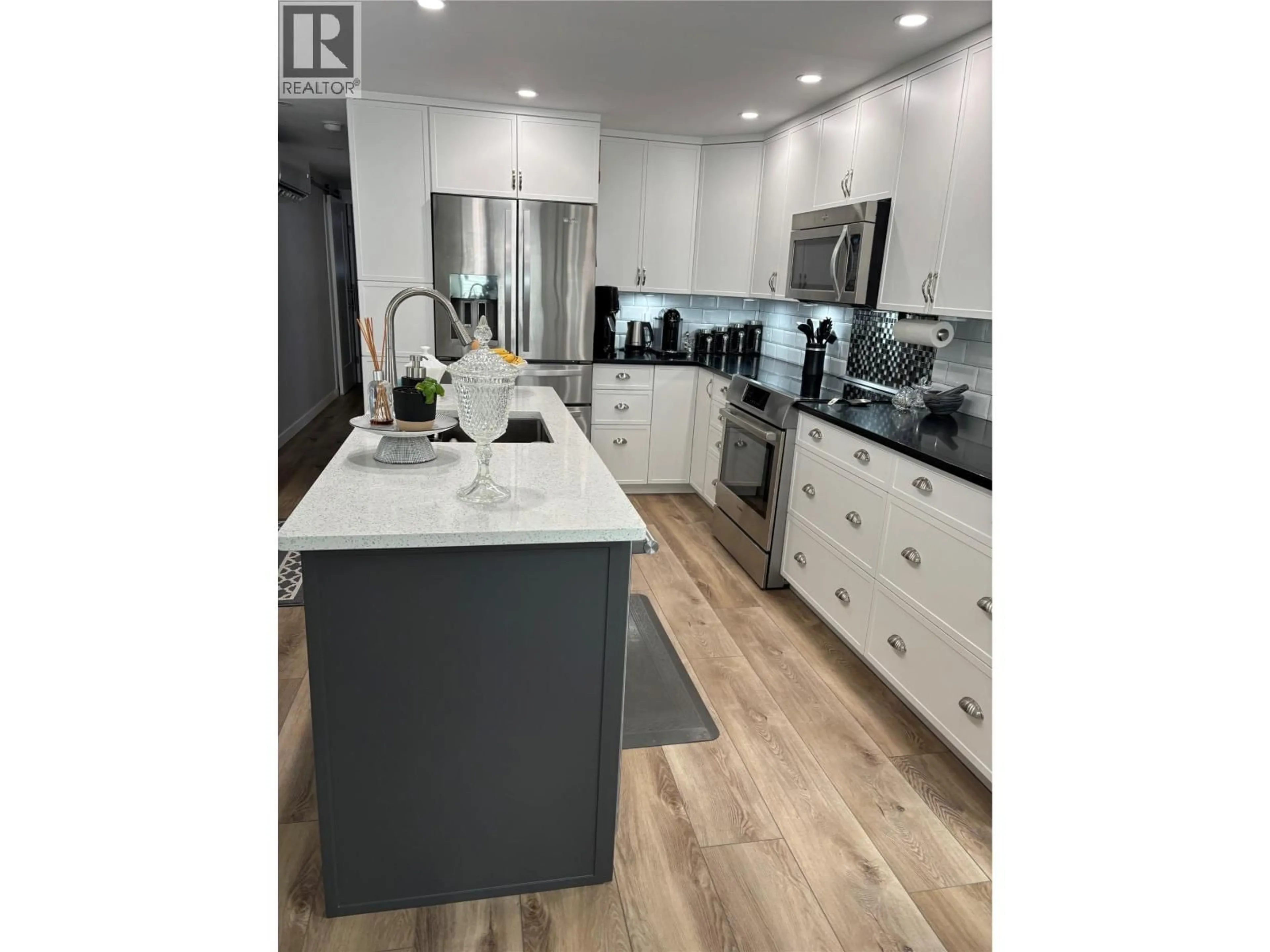 Open concept kitchen, wood/laminate floor for 53 - 8712 STEUART STREET, Summerland British Columbia V0H1Z6